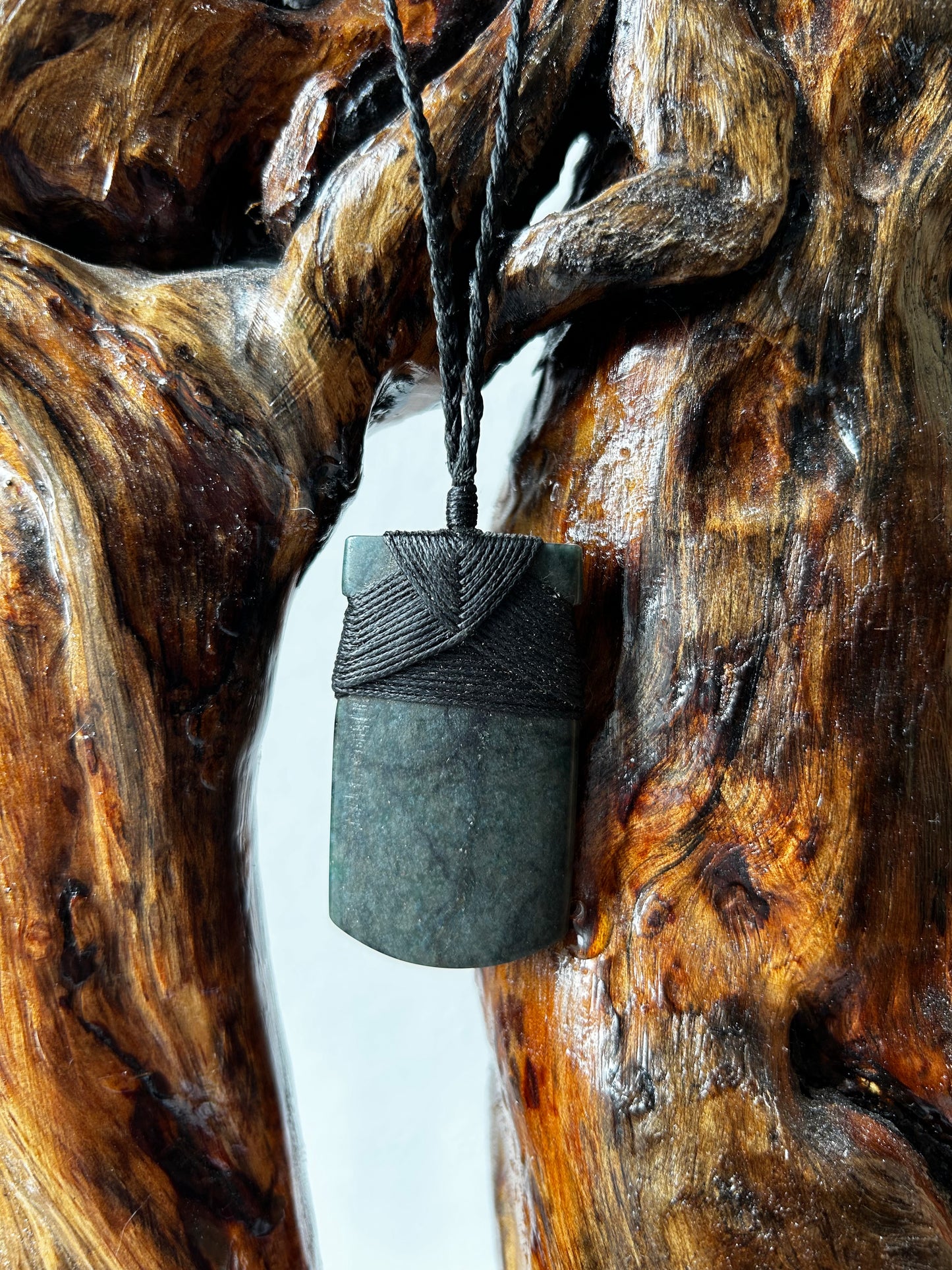 carved pounamu toki (adze) necklace with black lashing