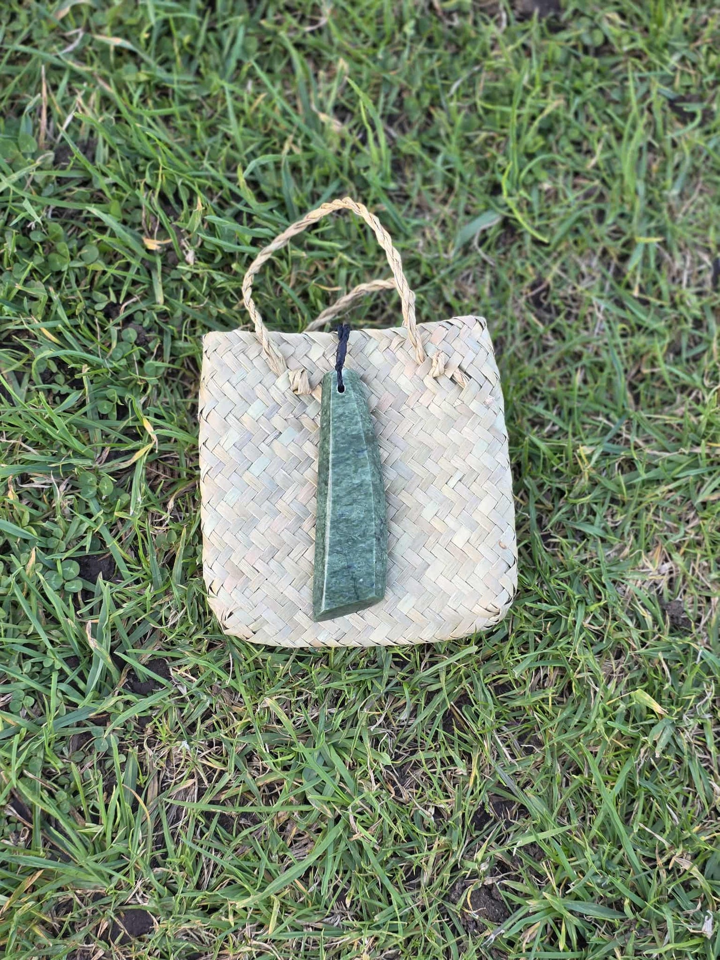 Asymmetrical pounamu greenstone toki (adze) necklace on black braid