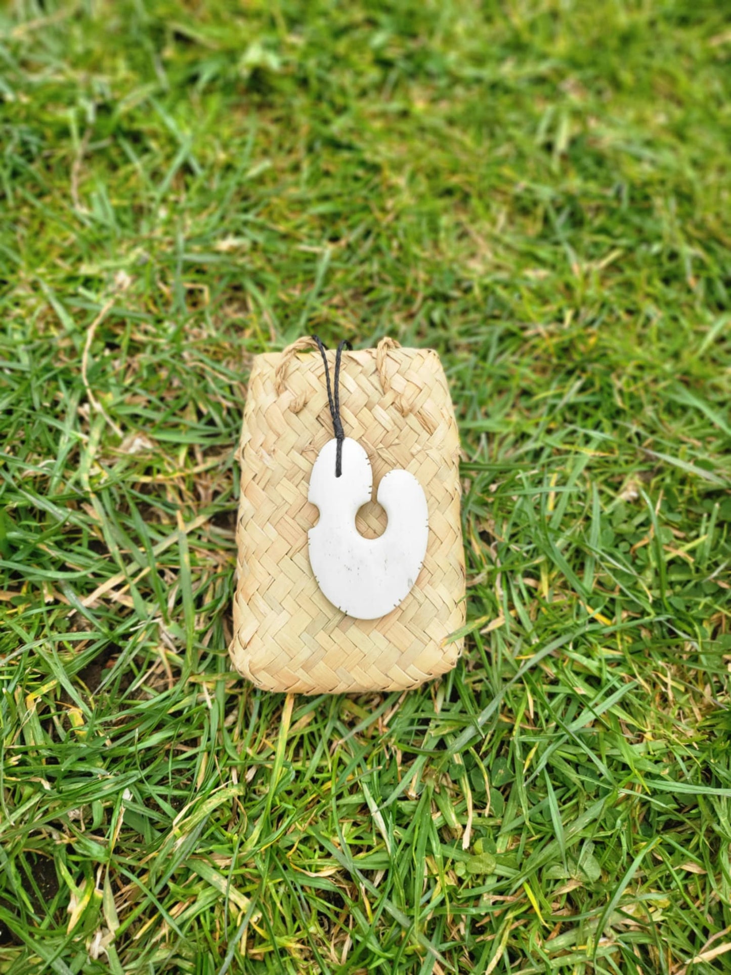 beautifully carved bone matau (hook) necklace with black cord