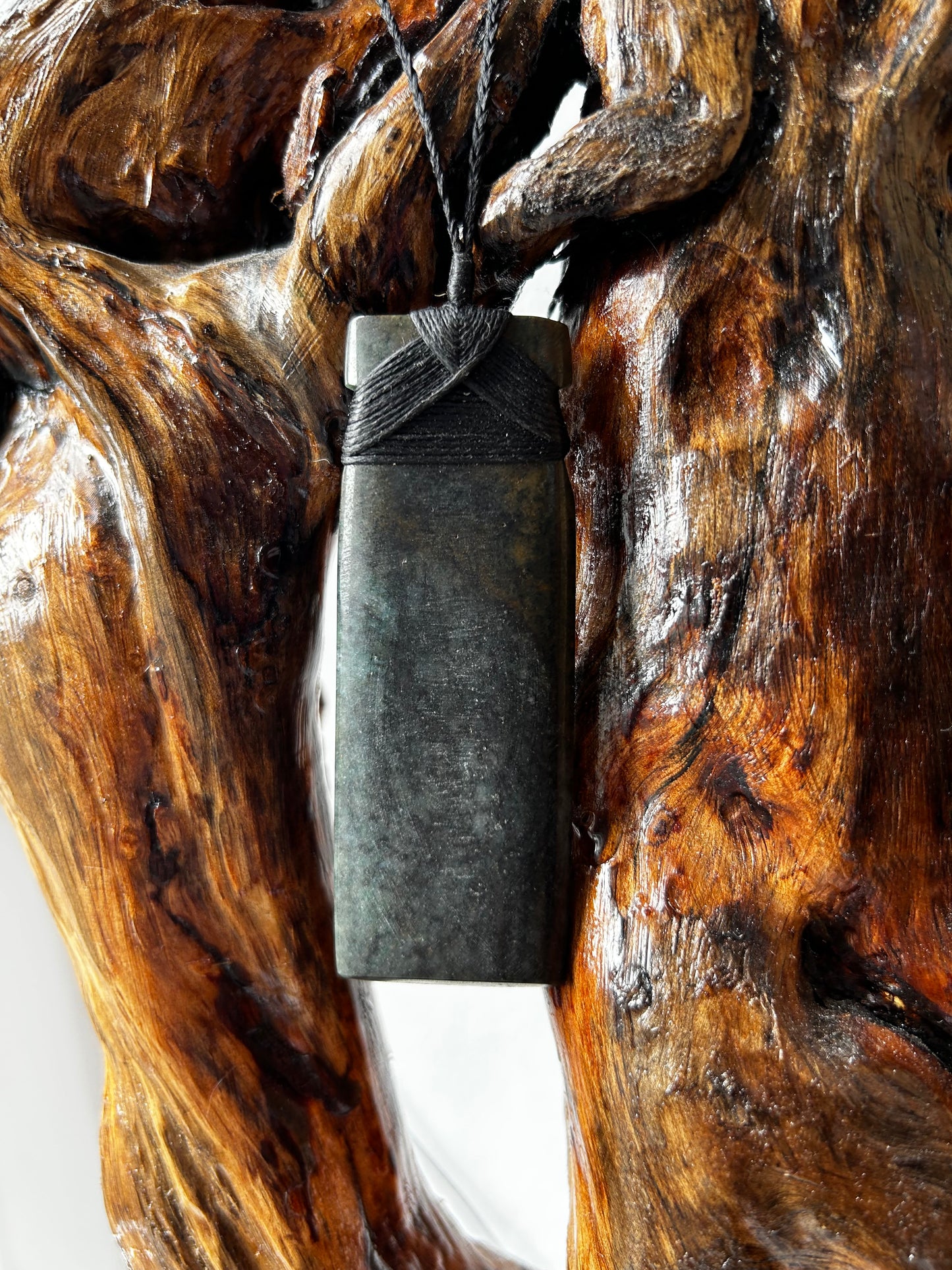 carved pounamu toki (adze) necklace with black lashing