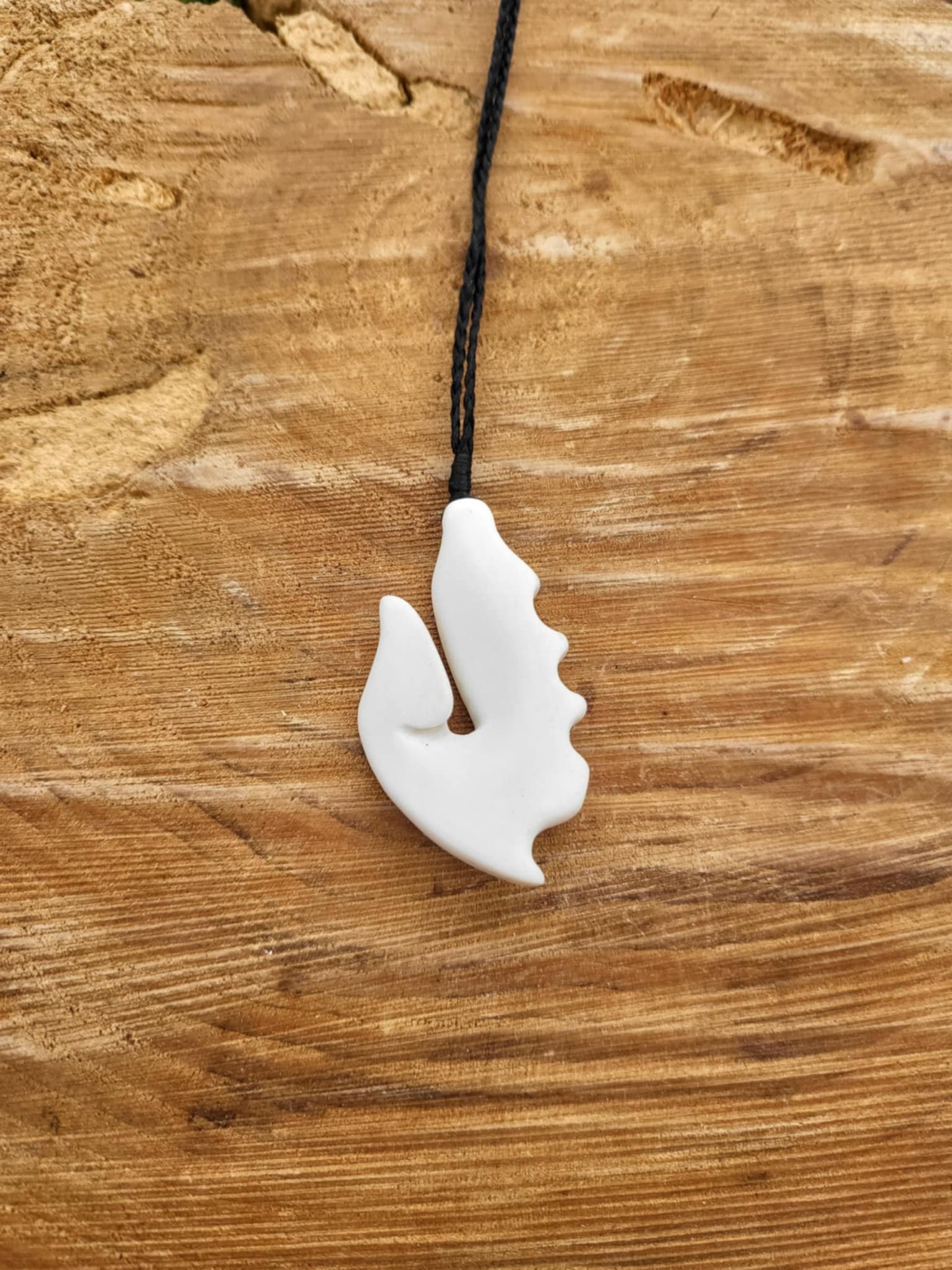 carved bone matau (hook) necklace on black cord