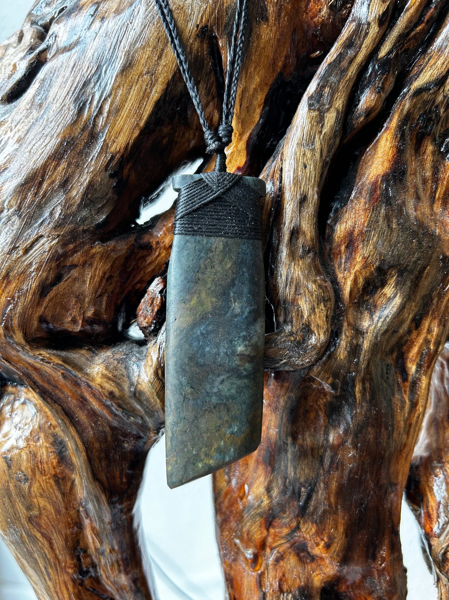 carved pounamu toki (adze) necklace with black lashing
