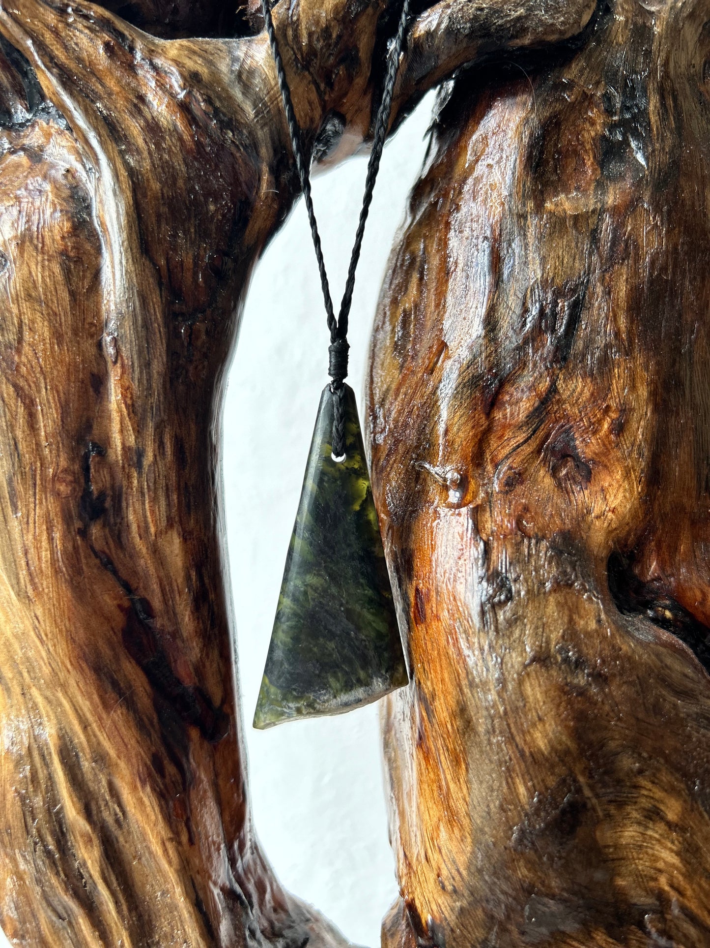 translucent carved pounamu tapu toru (triangular) necklace on black cord