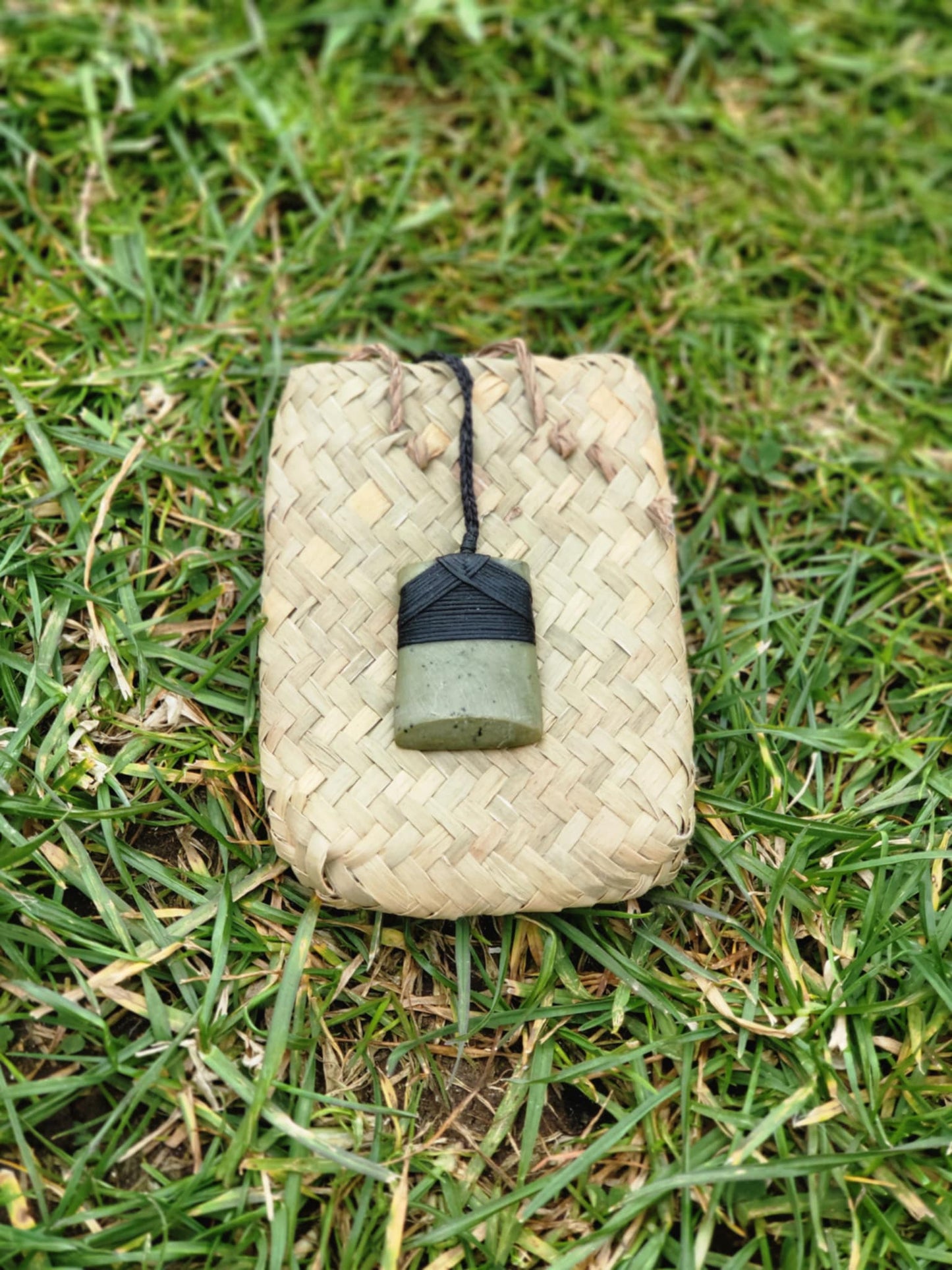 light green pounamu carved toki (adze) necklace on black cord