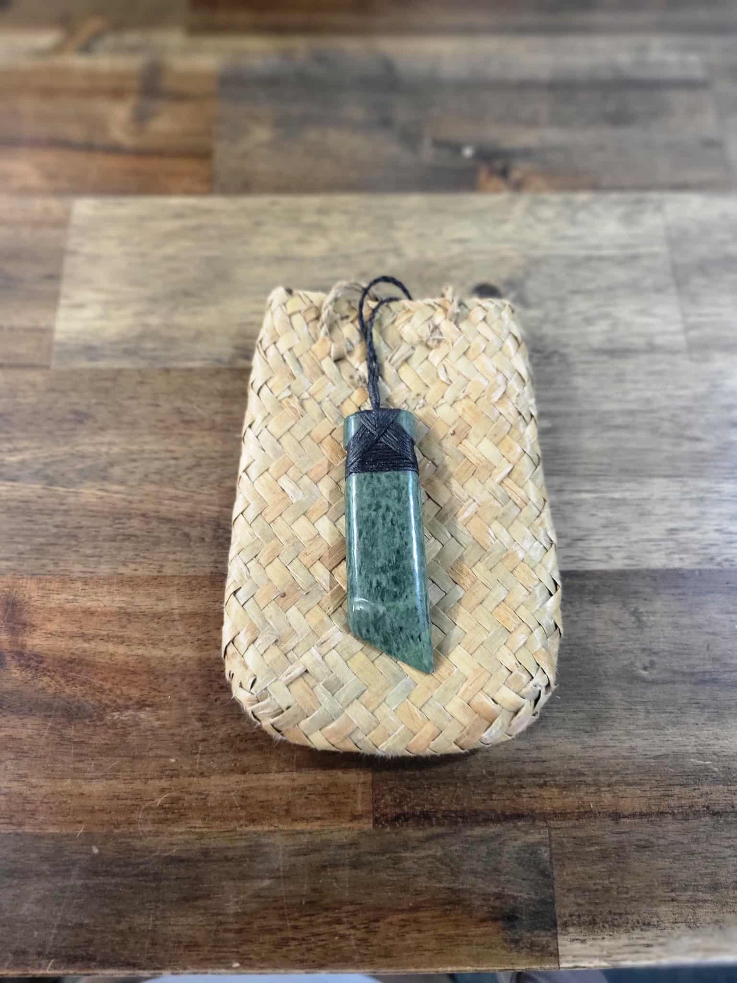 Asymmetrical pounamu greenstone toki (adze) necklace with black strapping