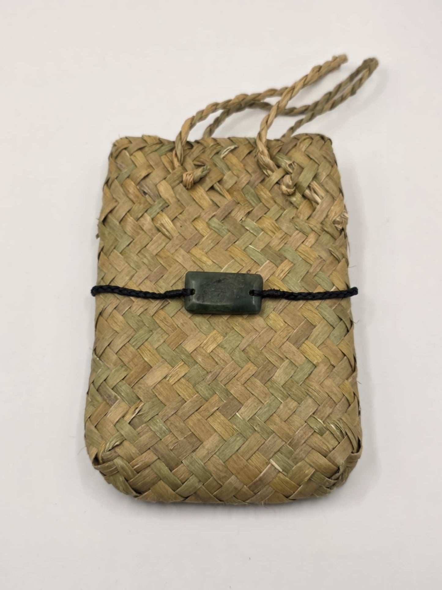 carved pounamu bracelet on black cord