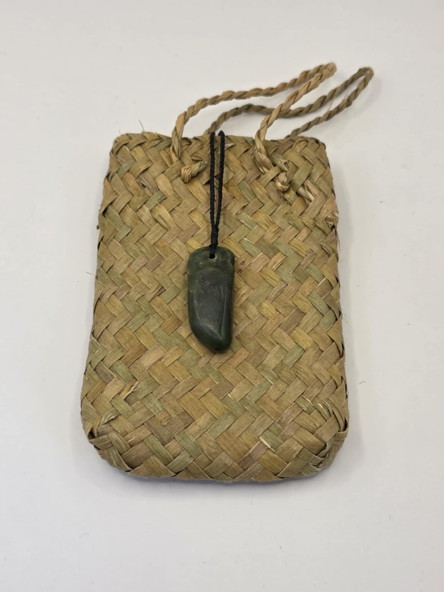 small carved pounamu roimata (tear drop) necklace, on black cord