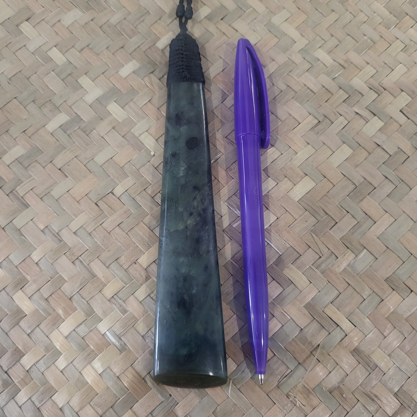 carved pounamu toki (adze) necklace with black lashing