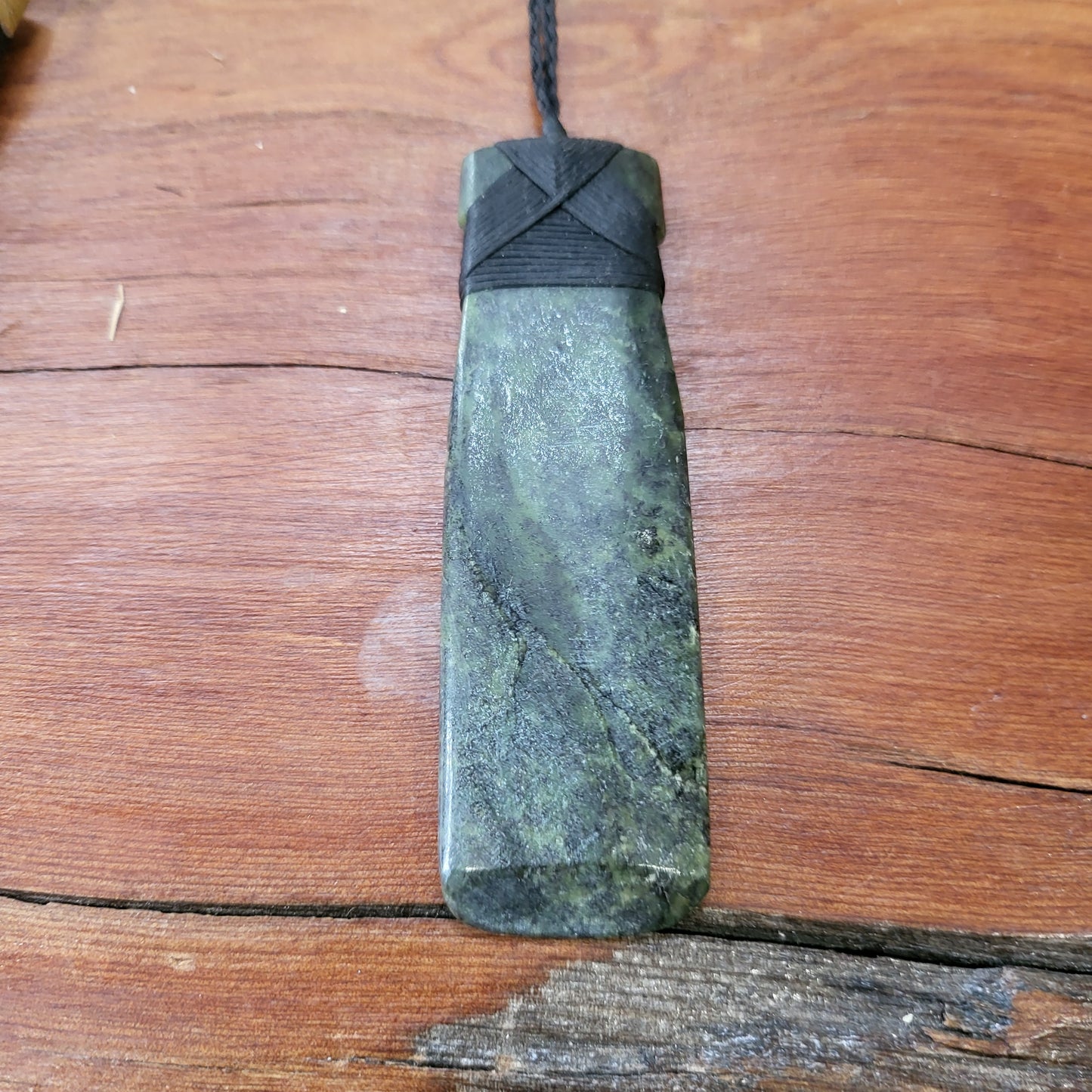 carved pounamu toki (adze) necklace, on black cord