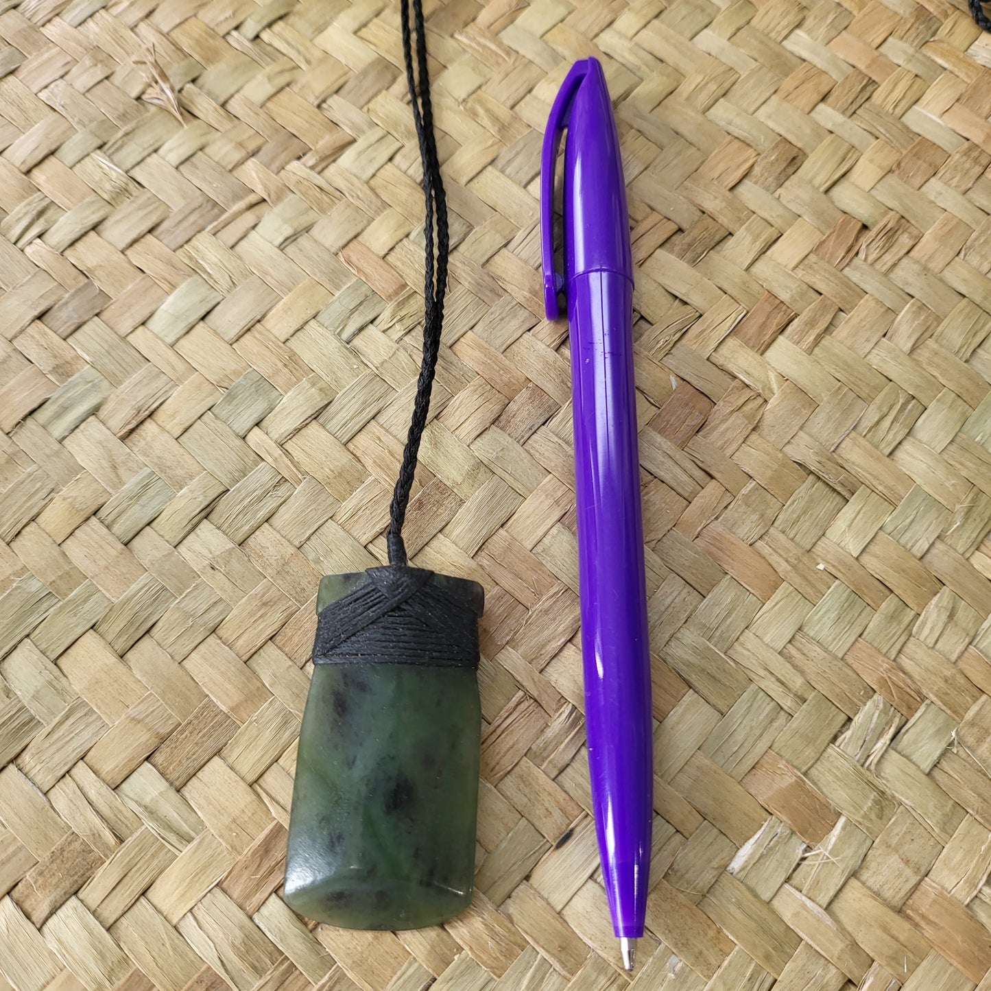 carved pounamu toki (adze) necklace, on black cord