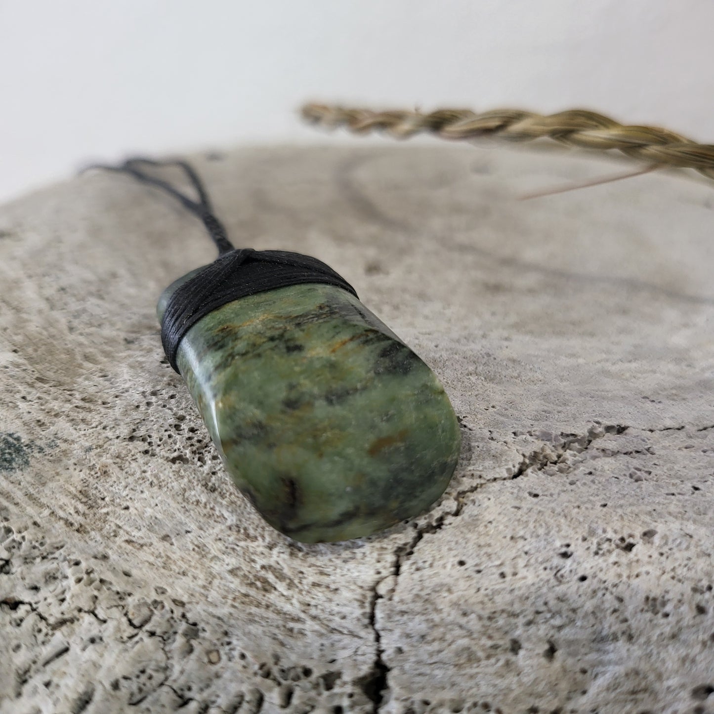 small carved pounamu toki (adze) necklace light green colour variations on black cord