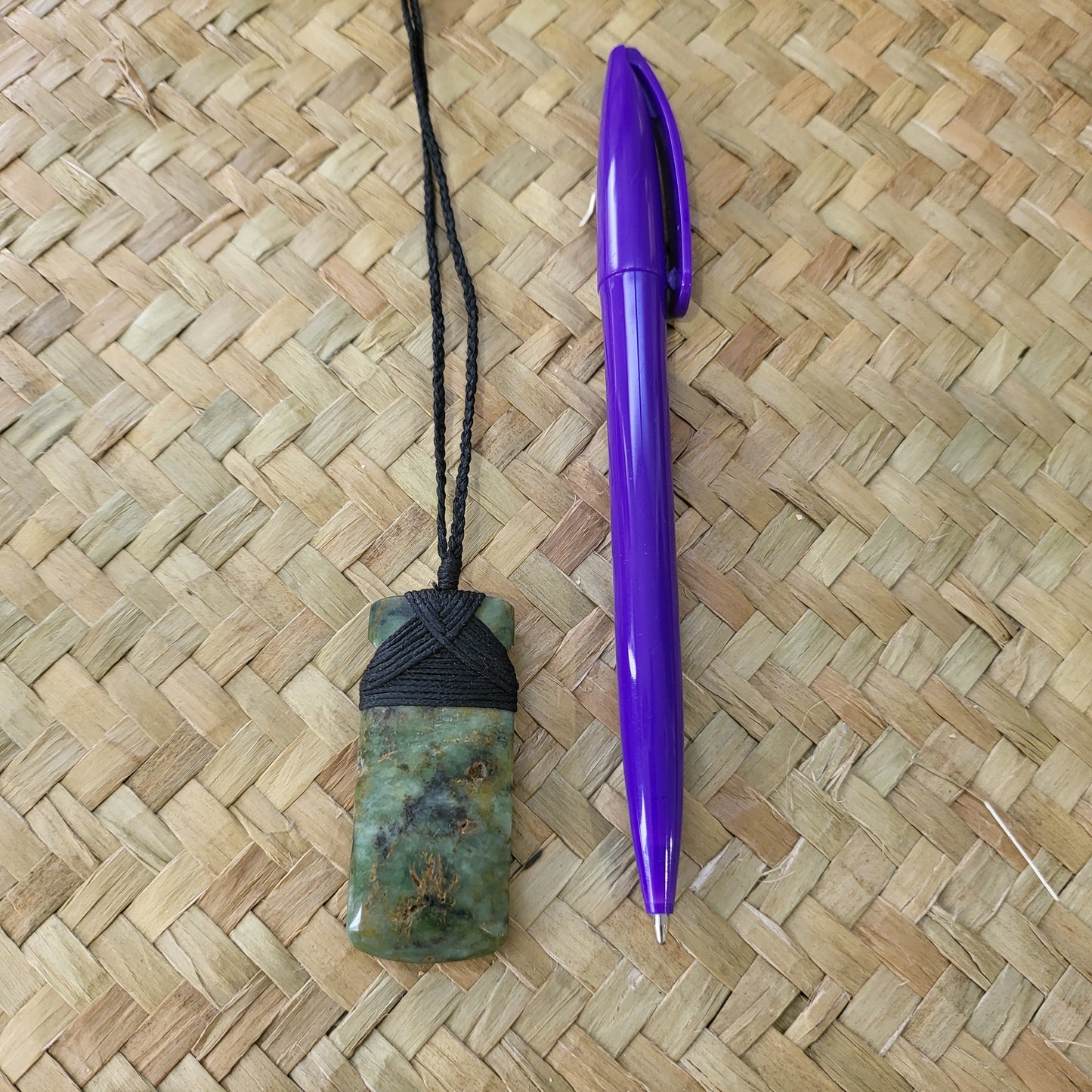 small carved pounamu toki (adze) necklace light green colour variations on black cord