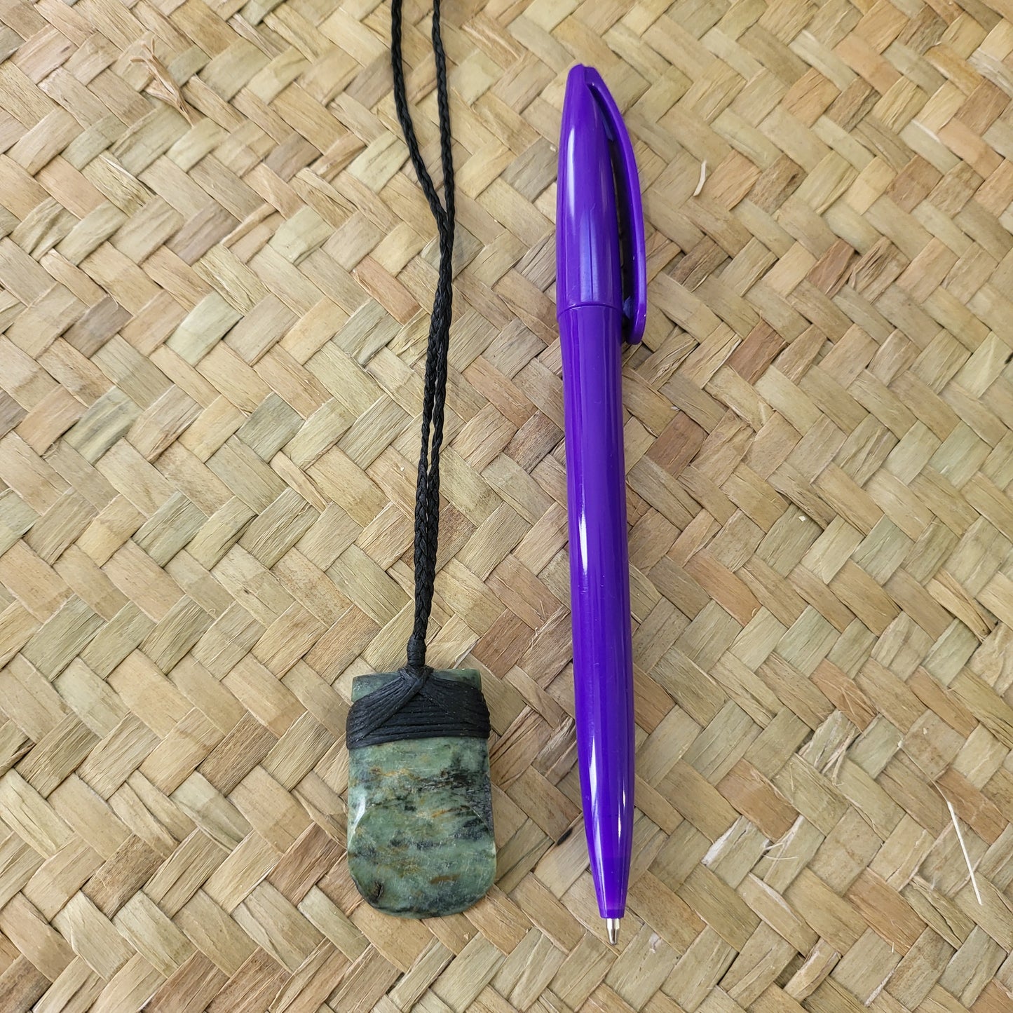 small carved pounamu toki (adze) necklace light green colour variations on black cord