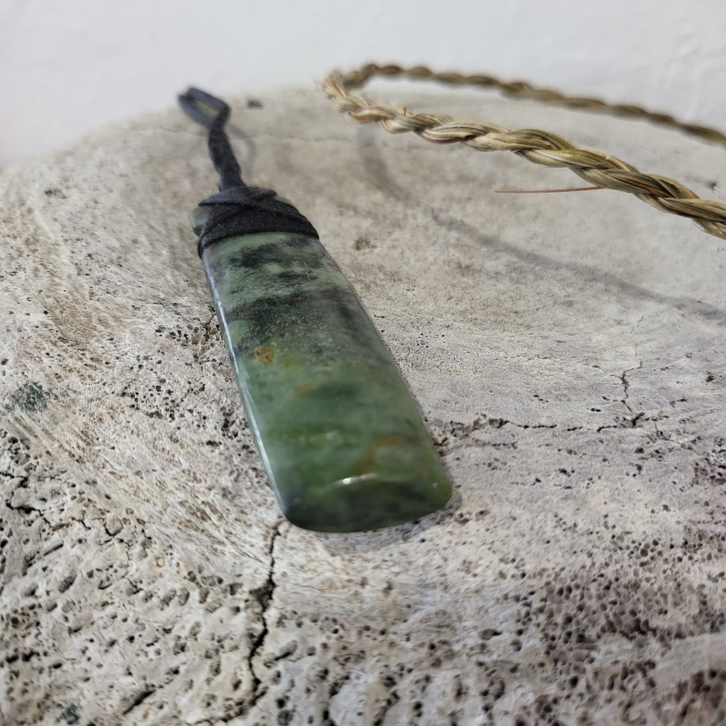 carved pounamu toki (adze) necklace light green colour variations on black cord