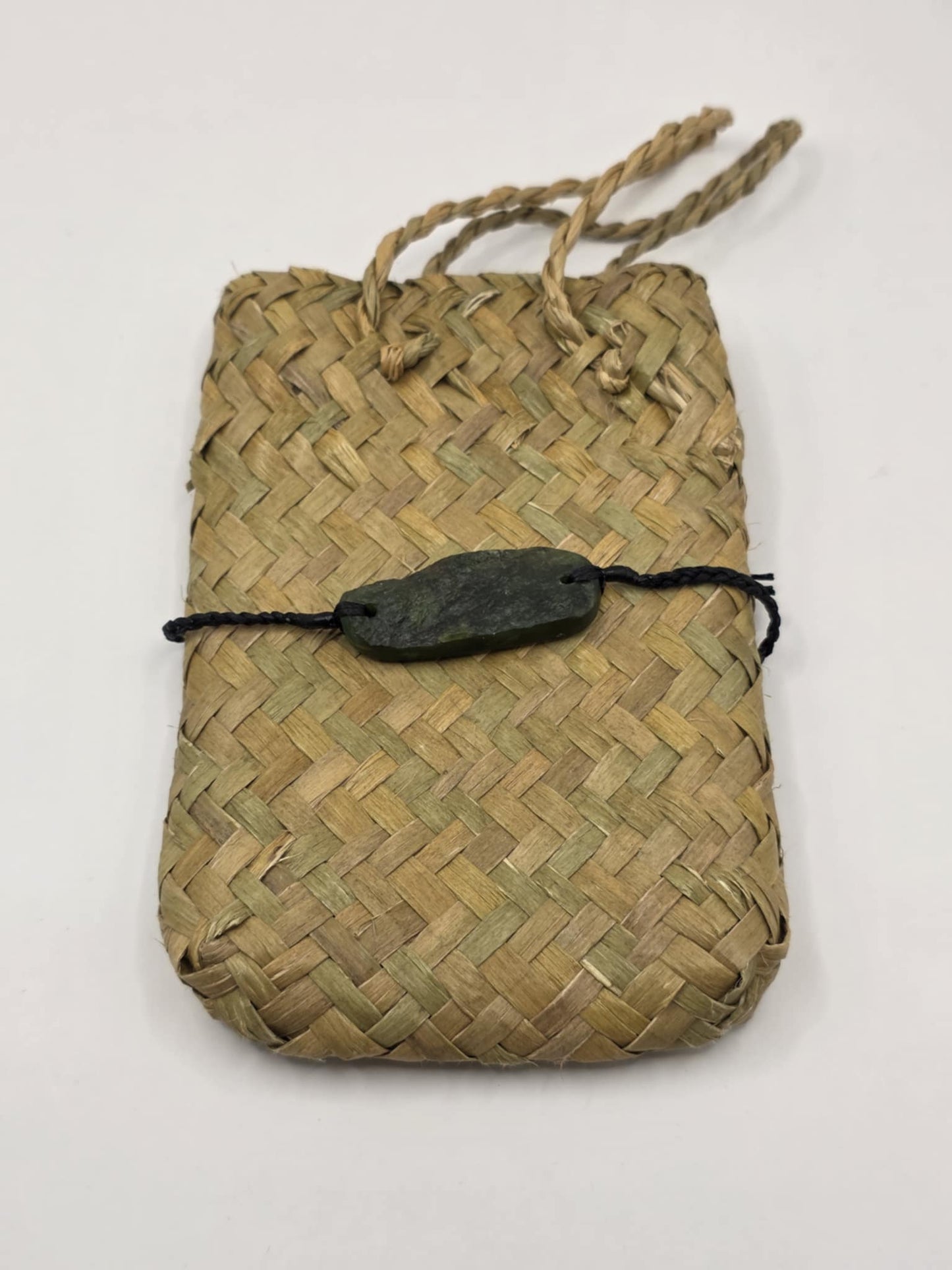 carved pounamu bracelet on black cord