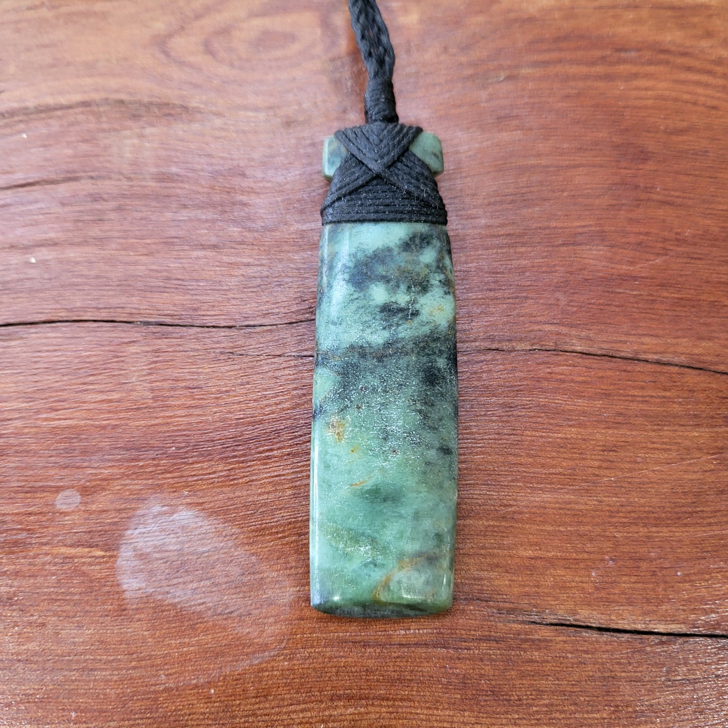 carved pounamu toki (adze) necklace light green colour variations on black cord