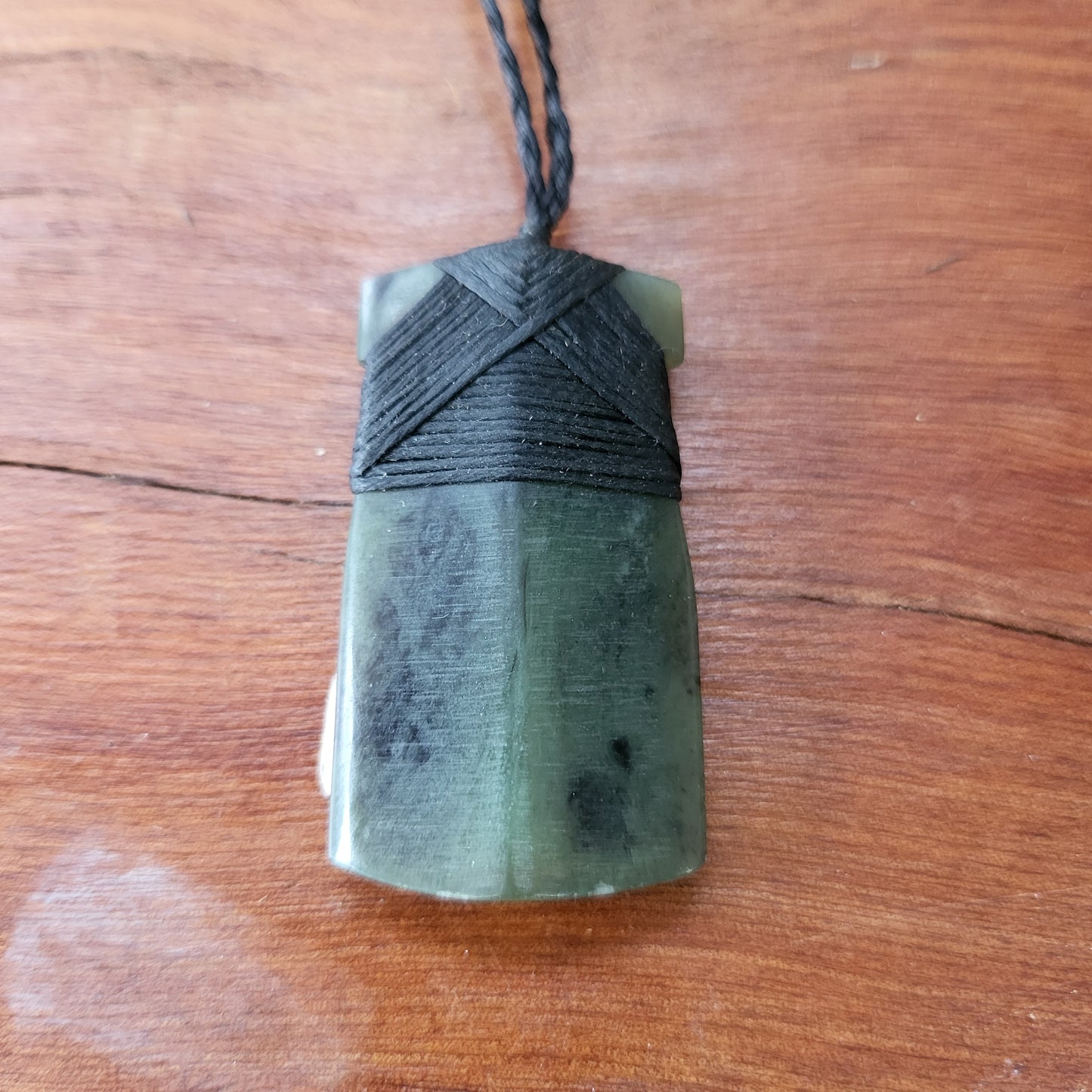 carved pounamu toki (adze) necklace, on black cord