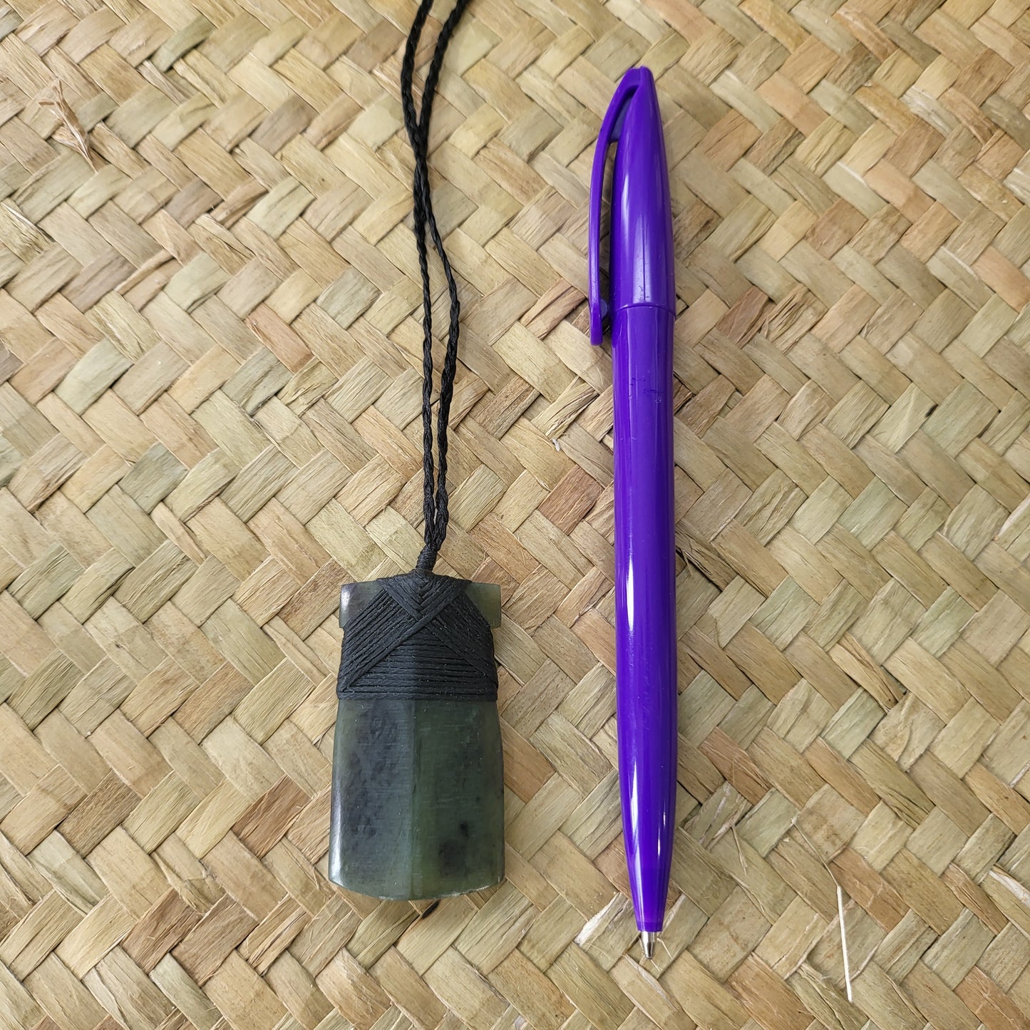 carved pounamu toki (adze) necklace, on black cord