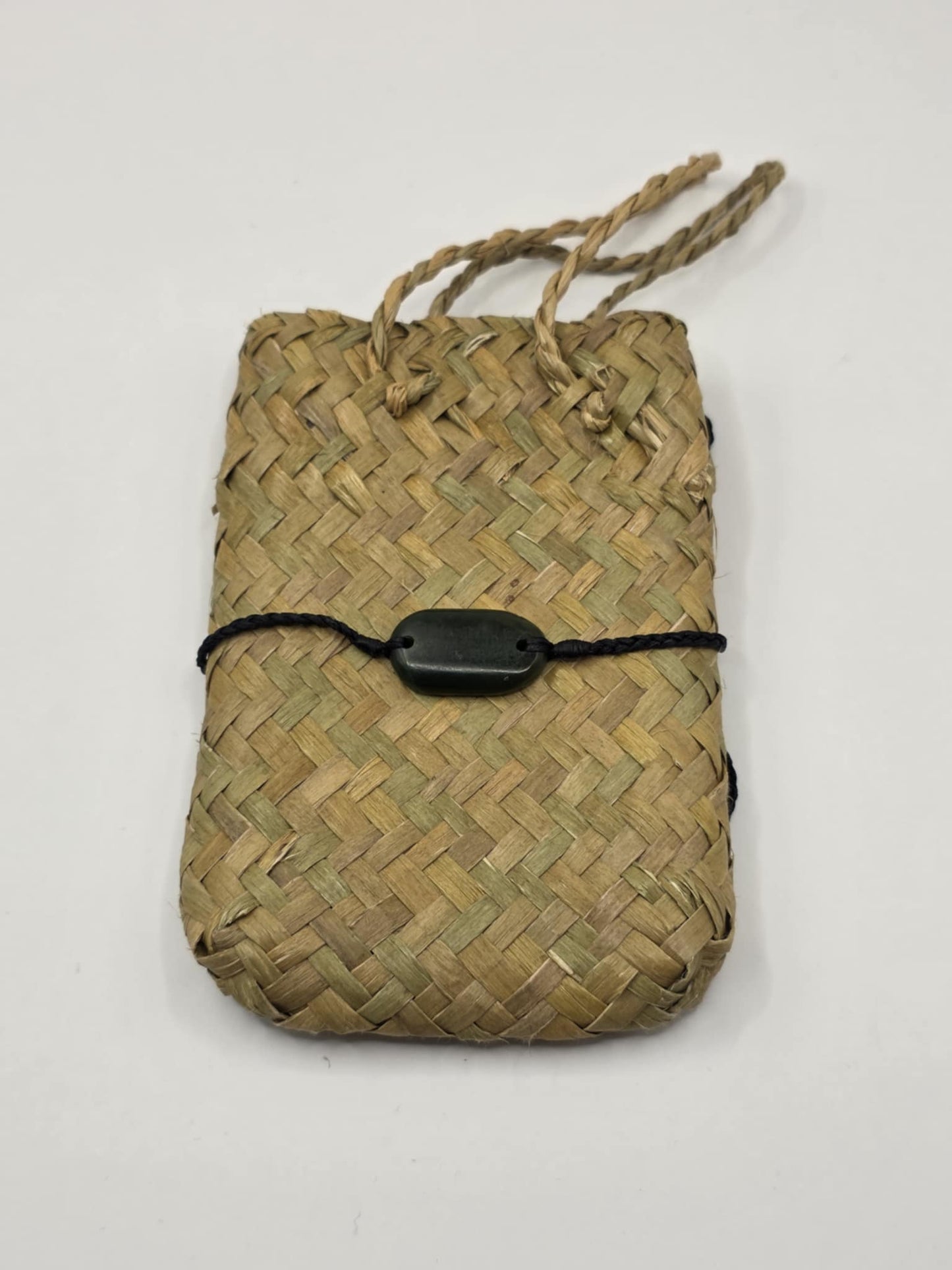 carved pounamu bracelet on black cord