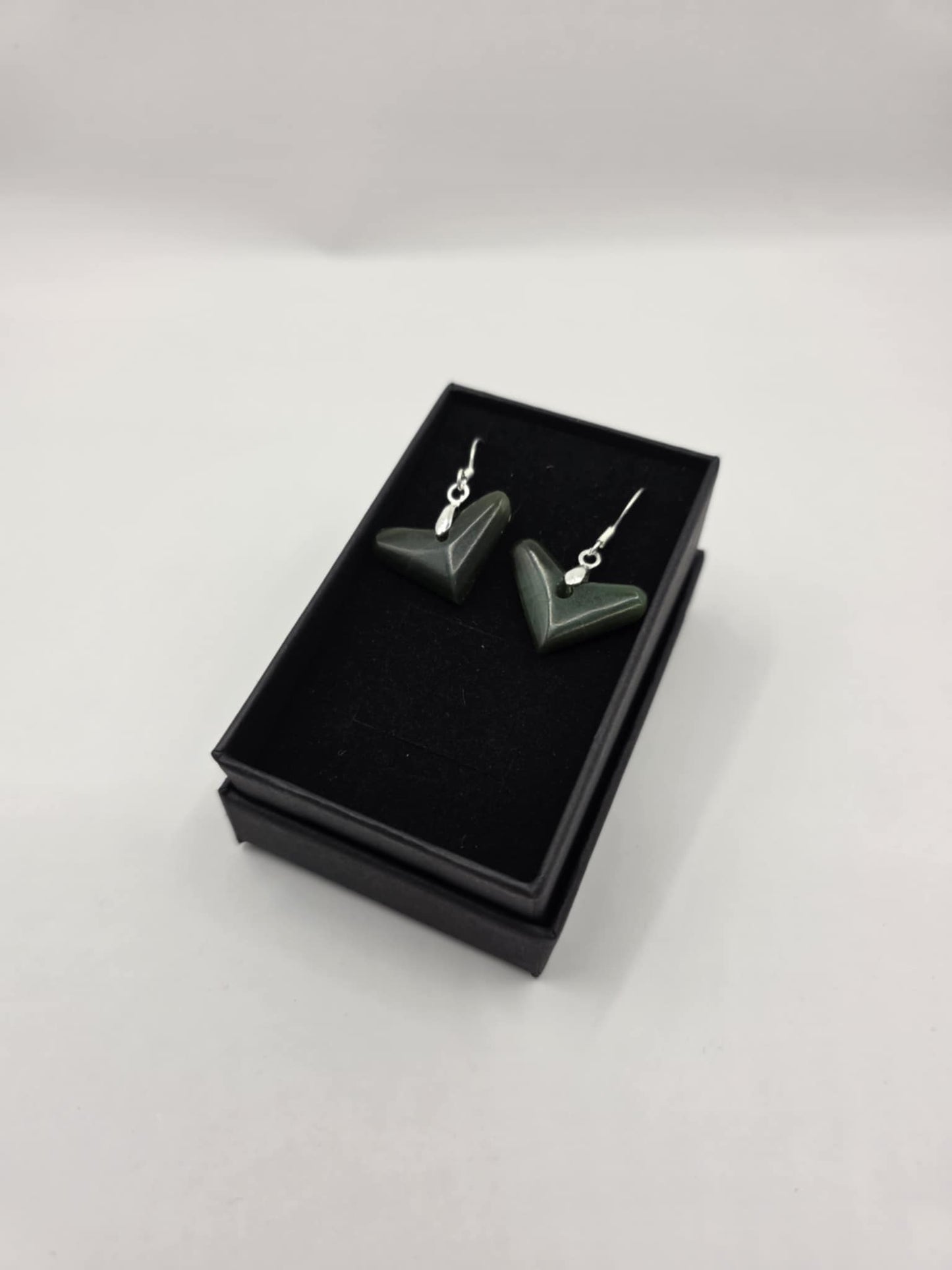 carved pounamu earrings (triangular), on silver colour fittings