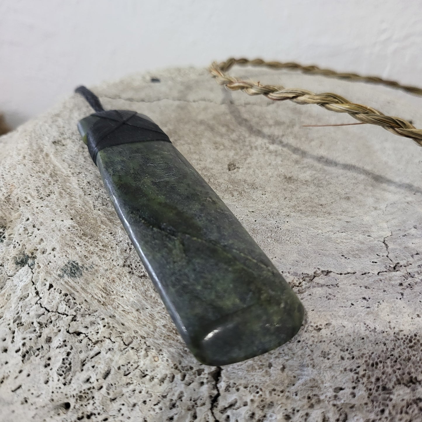 carved pounamu toki (adze) necklace, on black cord