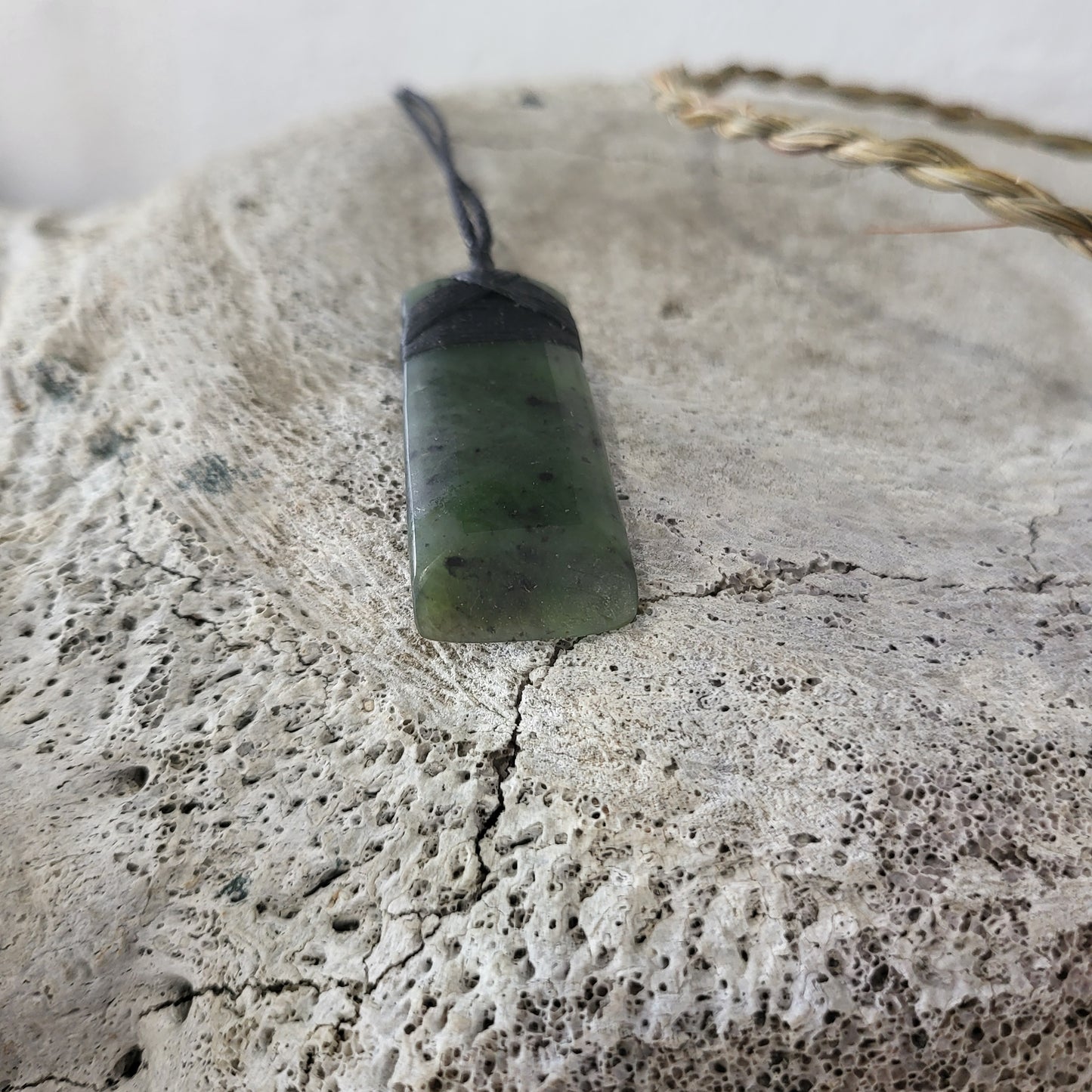 carved pounamu toki (adze) necklace, on black cord
