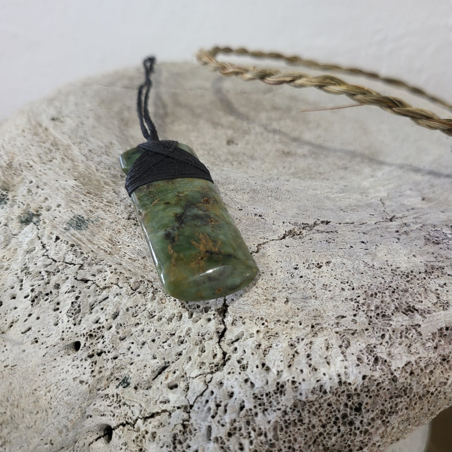 small carved pounamu toki (adze) necklace light green colour variations on black cord