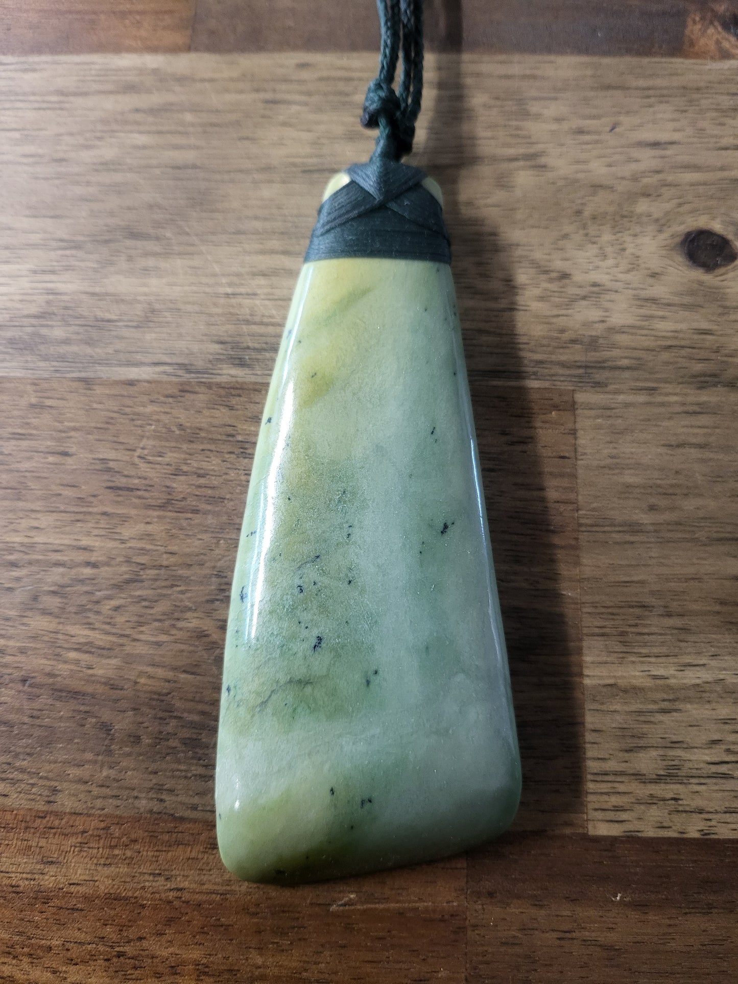 beautiful light green pounamu (greenstone) toki (adze necklace) with black lashing