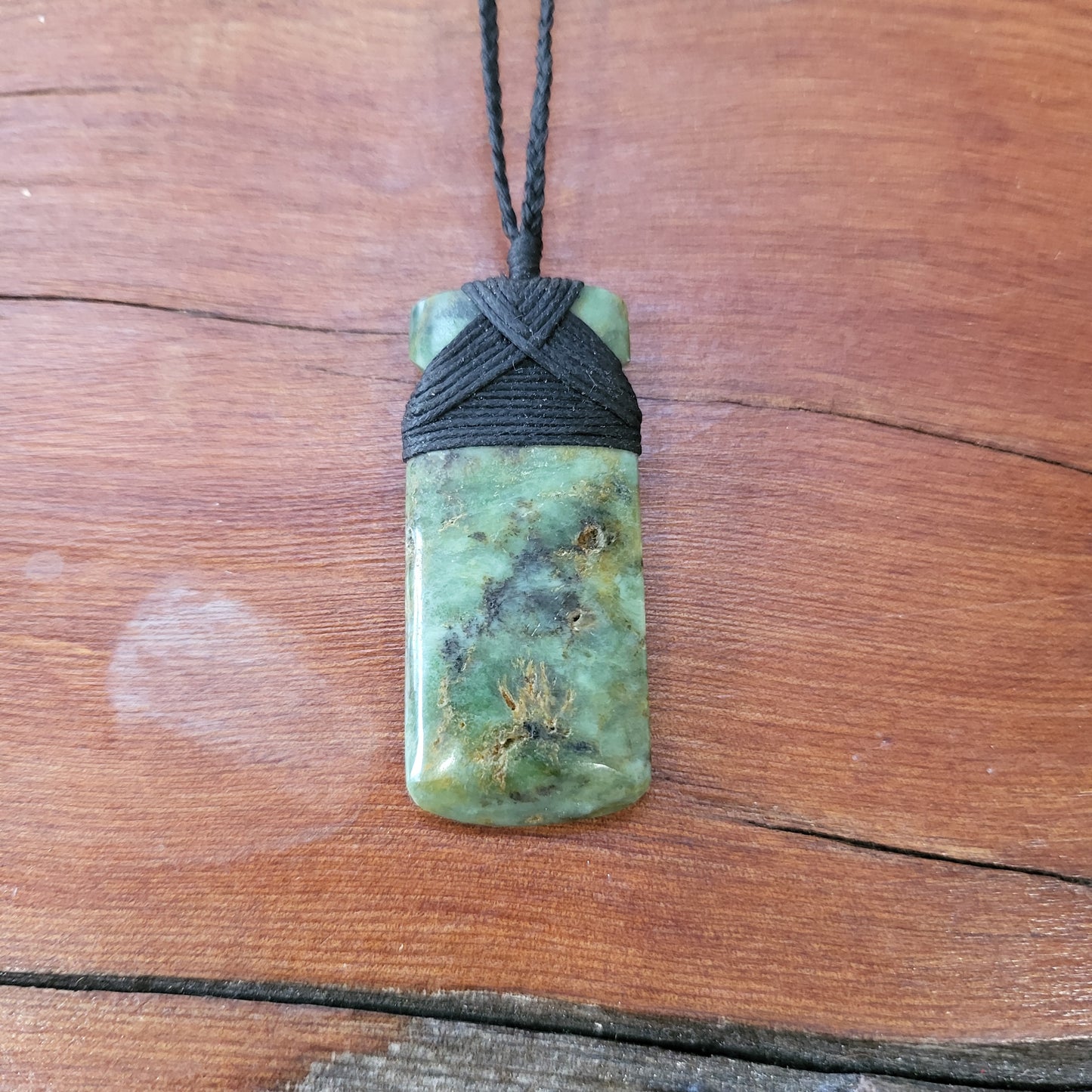small carved pounamu toki (adze) necklace light green colour variations on black cord