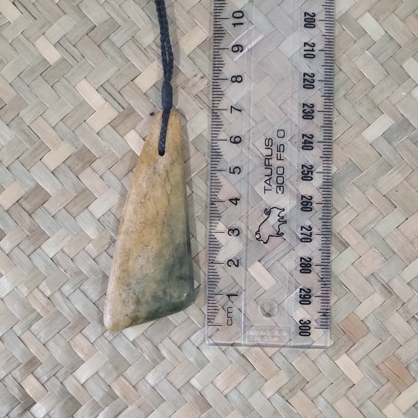 carved pounamu toki (adze) necklace, on black cord, yellow and green colour variation