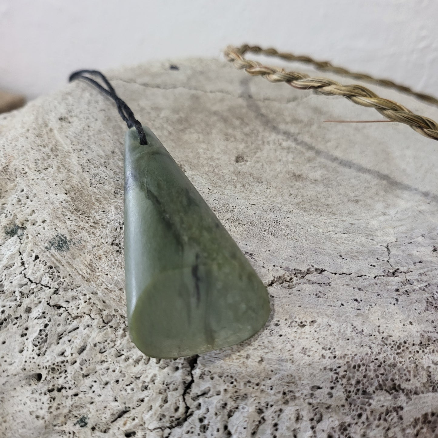carved pounamu triangular toki (adze) necklace, on black cord