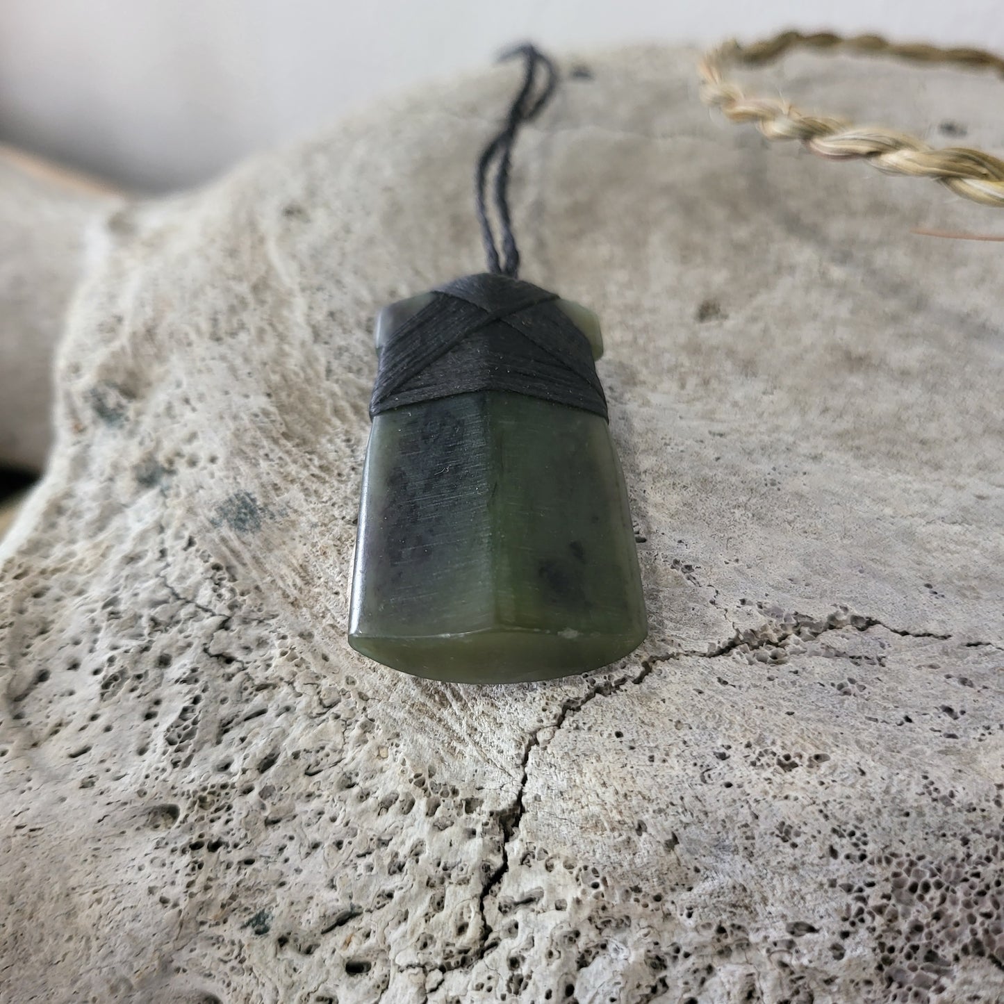 carved pounamu toki (adze) necklace, on black cord