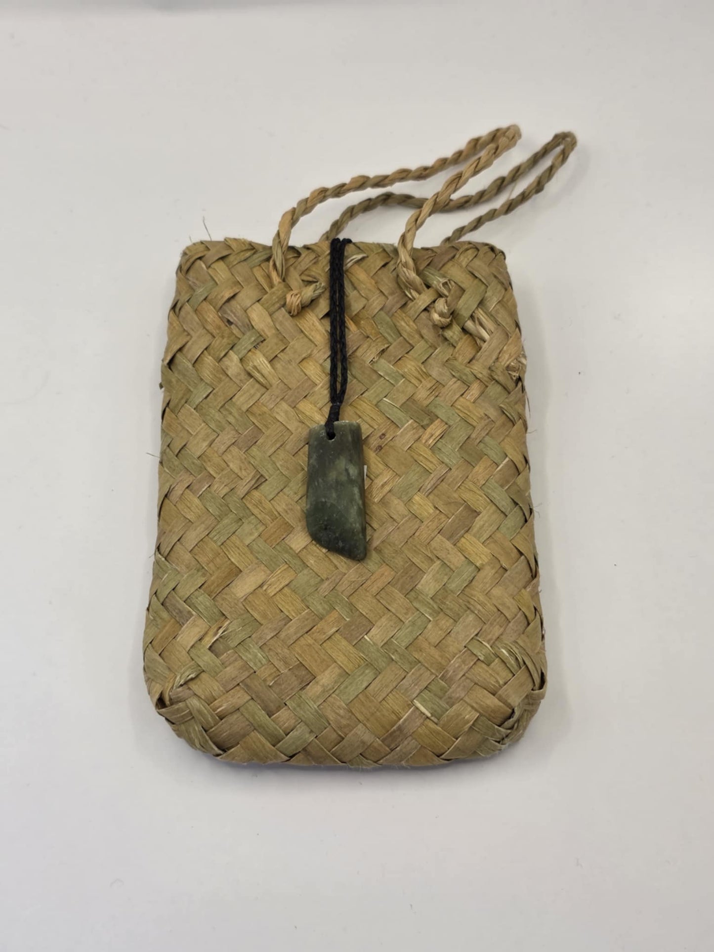 small carved pounamu toki (adze) necklace, on black cord