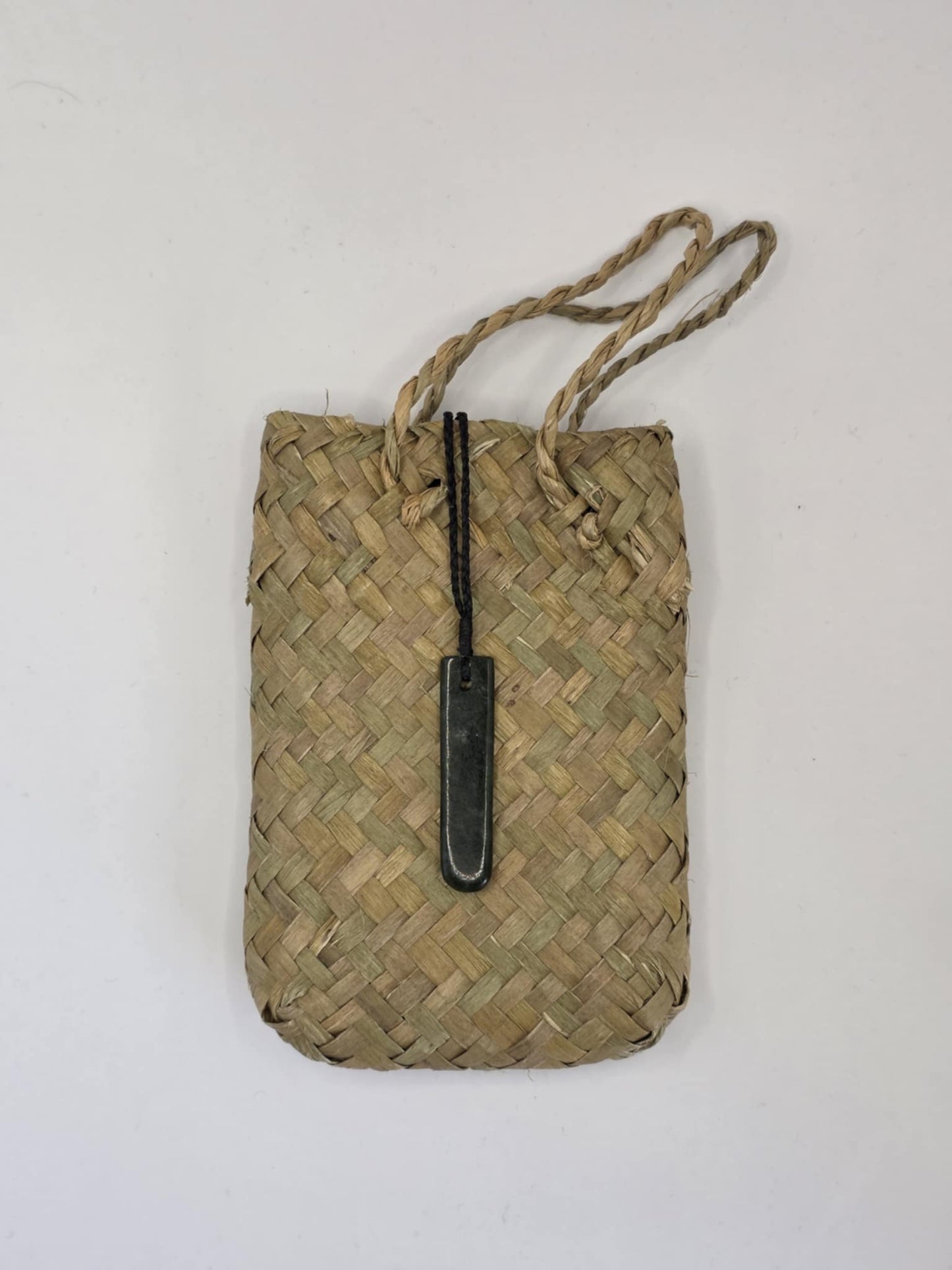 small carved pounamu toki (adze) necklace, on black cord