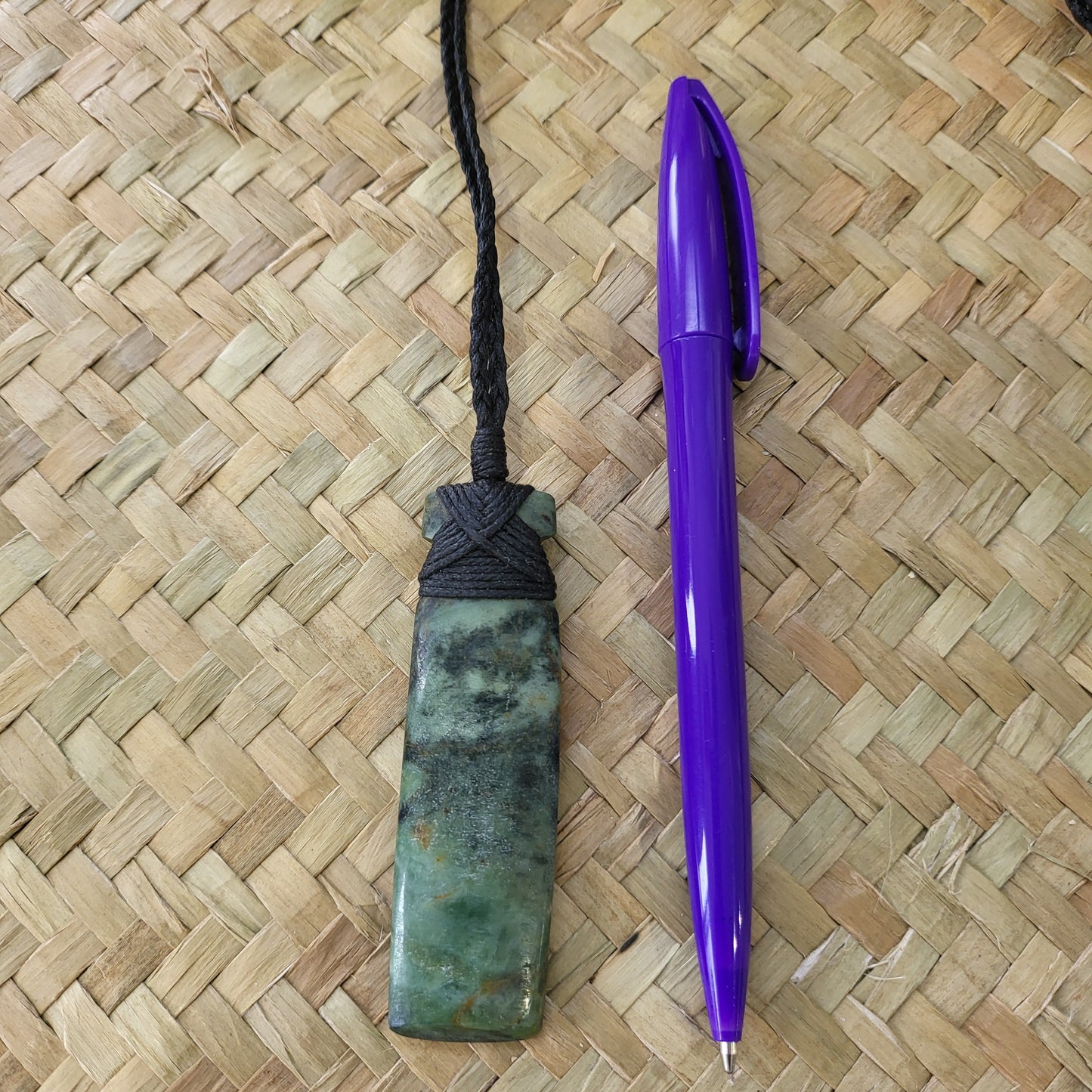 carved pounamu toki (adze) necklace light green colour variations on black cord