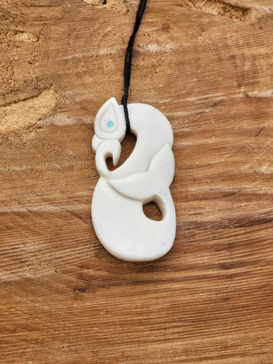 carved bone manaia necklace with whale tail on black cord