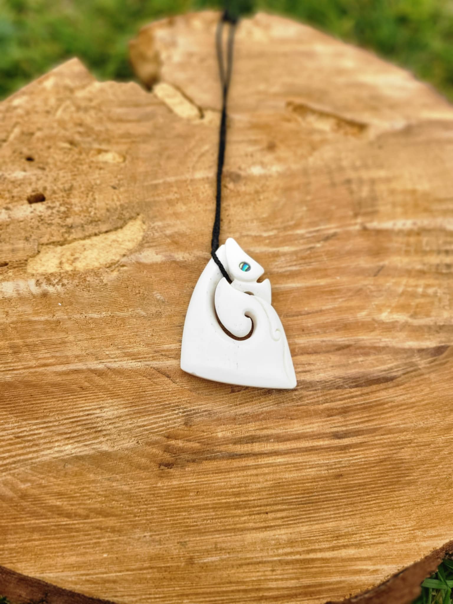 carved bone matau manaia necklace (triangular shape) on black cord
