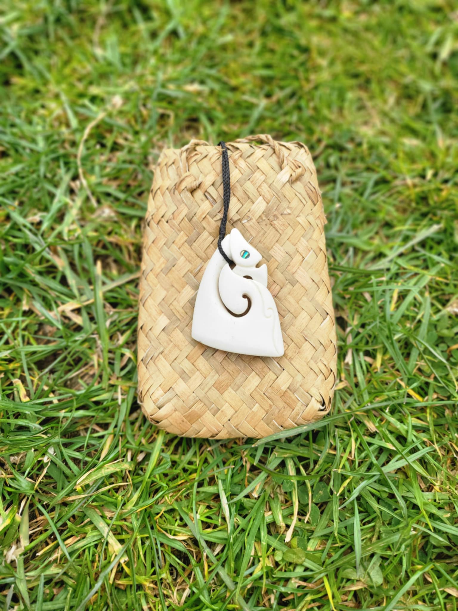 carved bone matau manaia necklace (triangular shape) on black cord