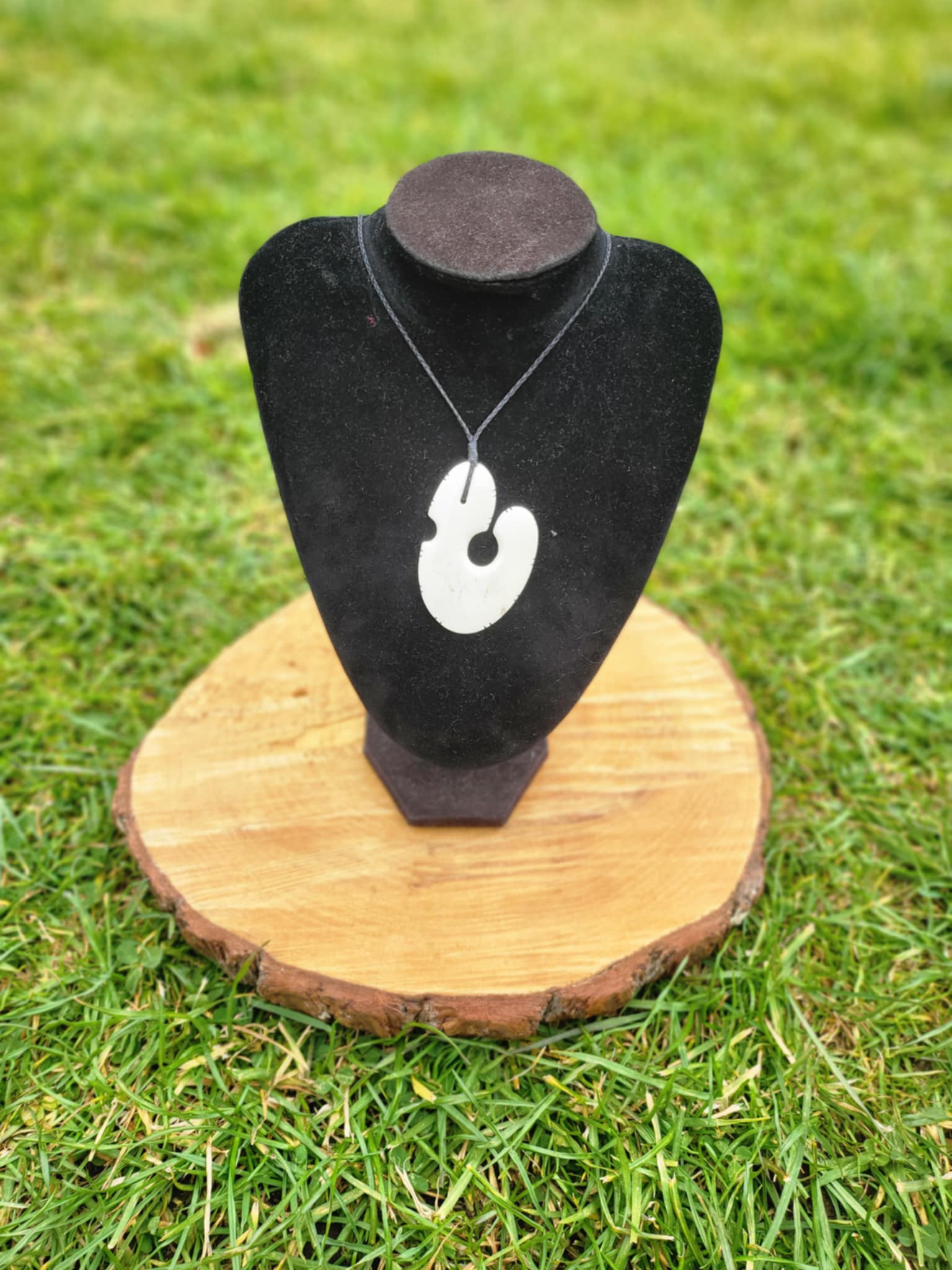 beautifully carved bone matau (hook) necklace with black cord