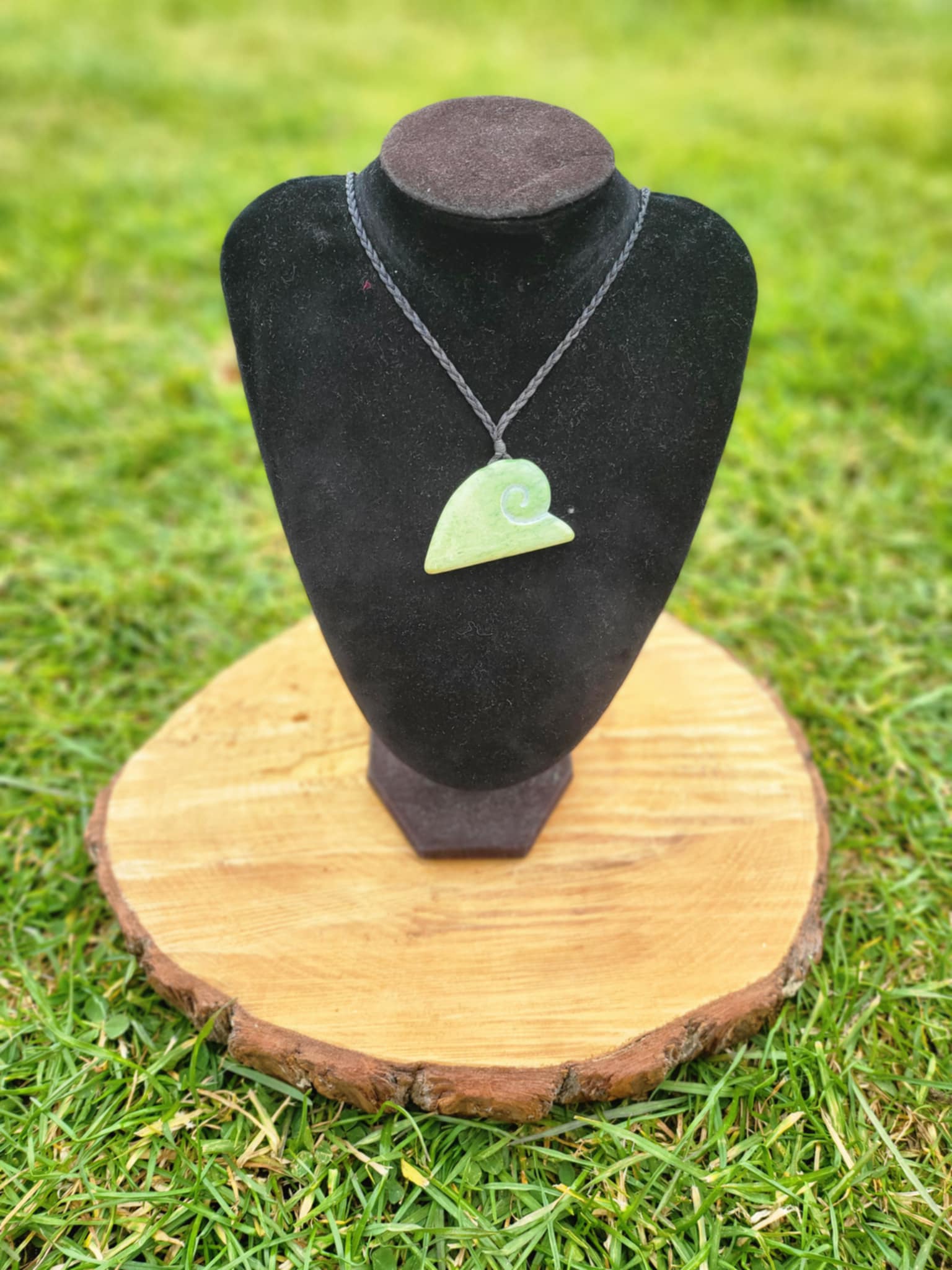 ngaru (wave) carved pounamu necklace on black cord