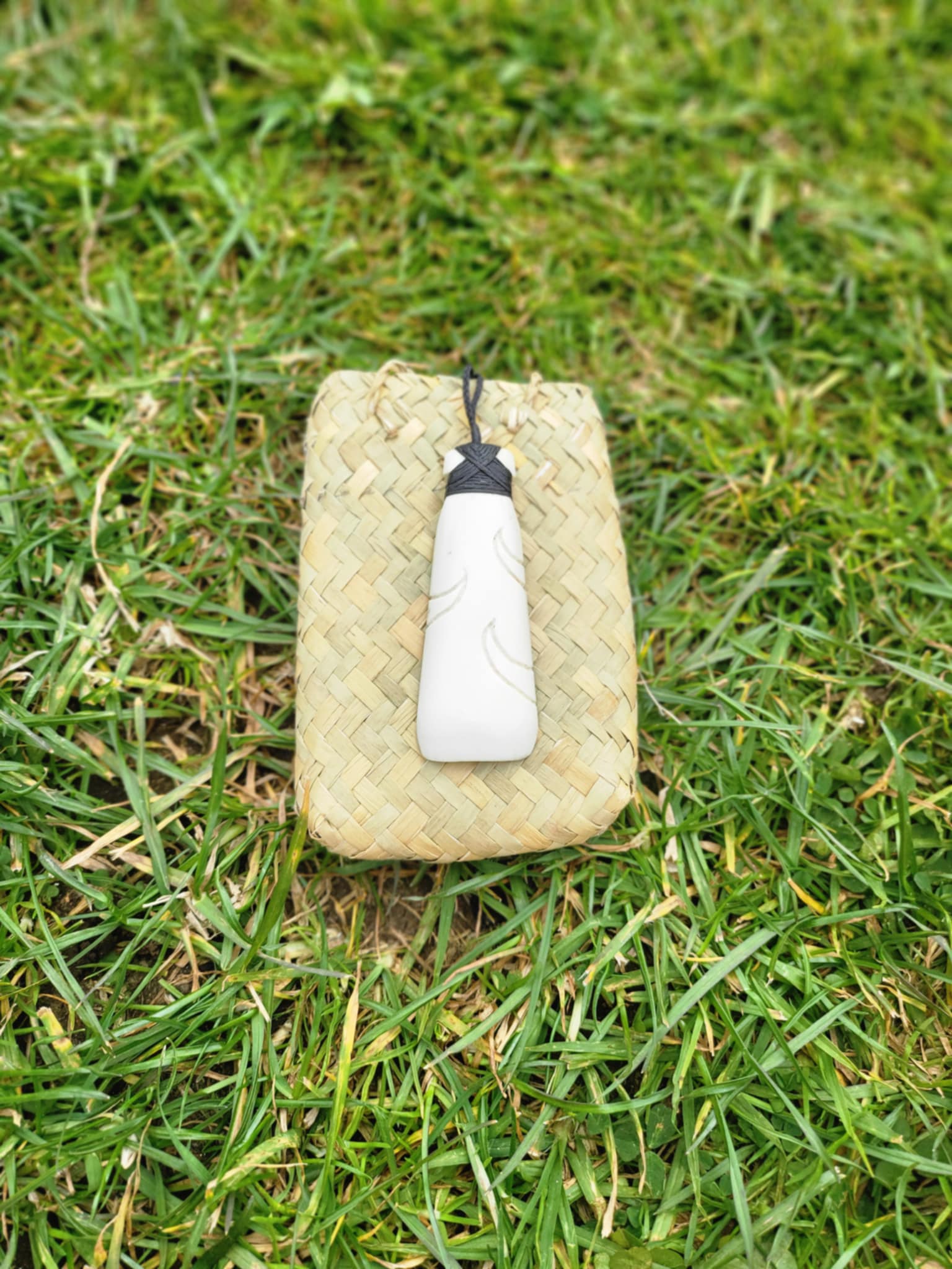 carved bone toki (adze) on black cord