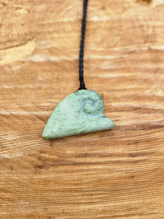 ngaru (wave) carved pounamu necklace on black cord
