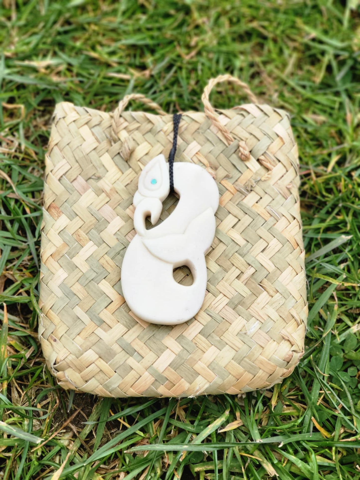 carved bone manaia necklace with whale tail on black cord