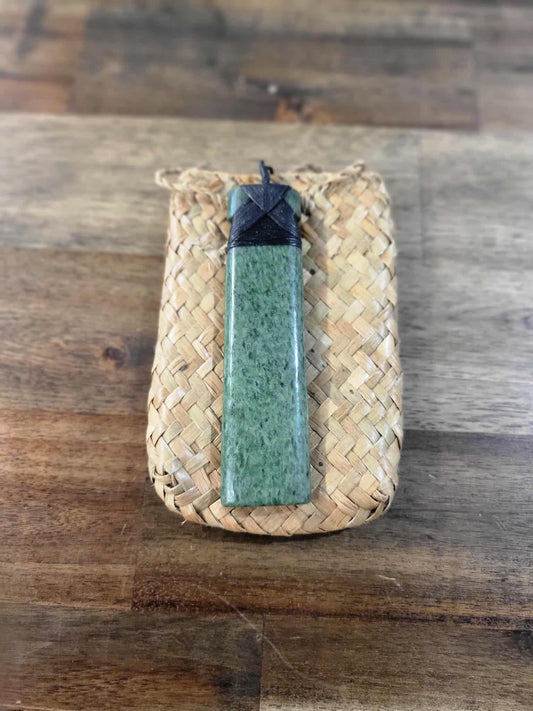 Light green pounamu greenstone toki (adze) necklace with black strapping