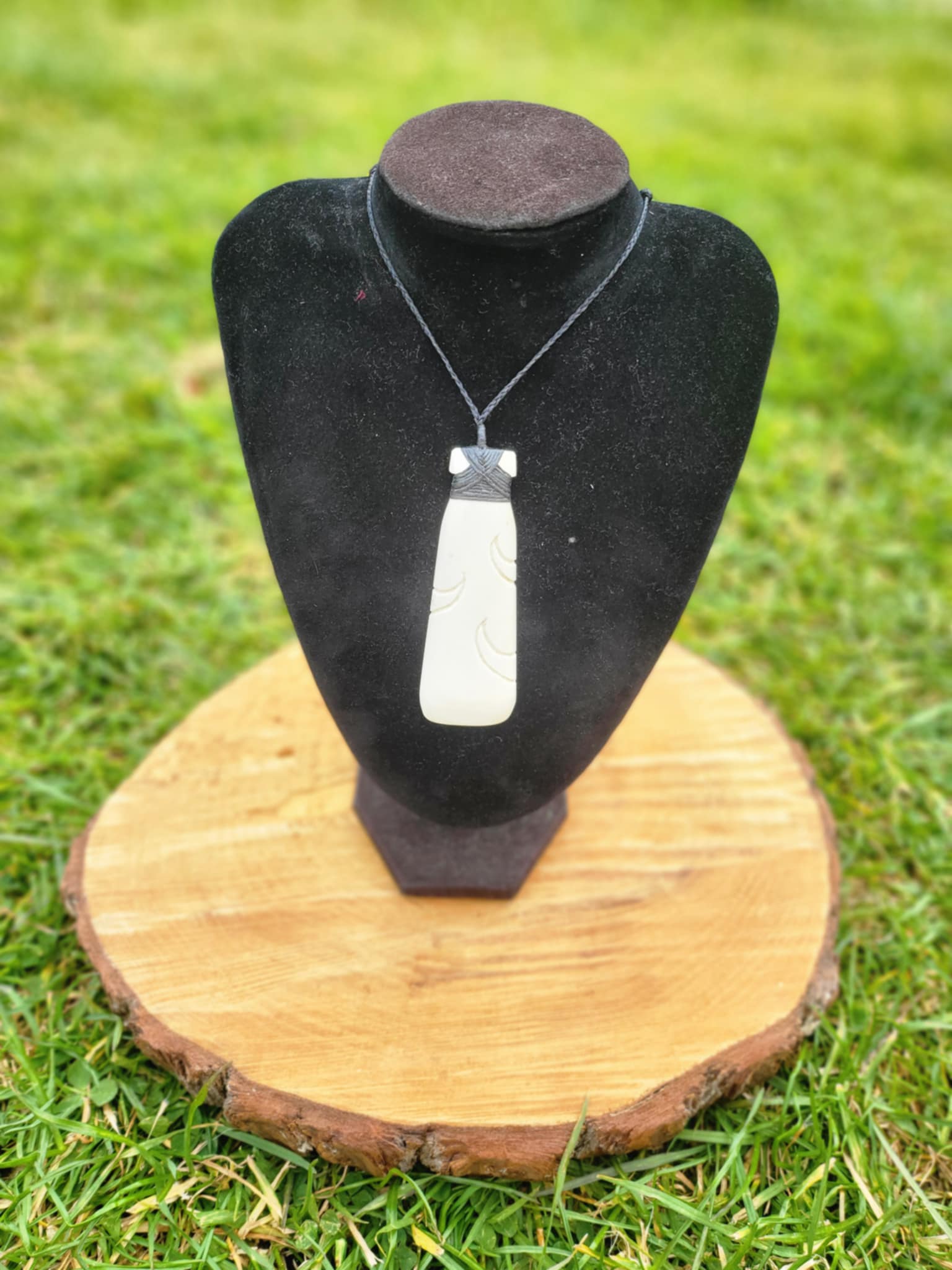 carved bone toki (adze) on black cord