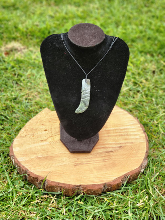 carved pounamu kapeu (notched rod to recite whakapapa) necklace on cord