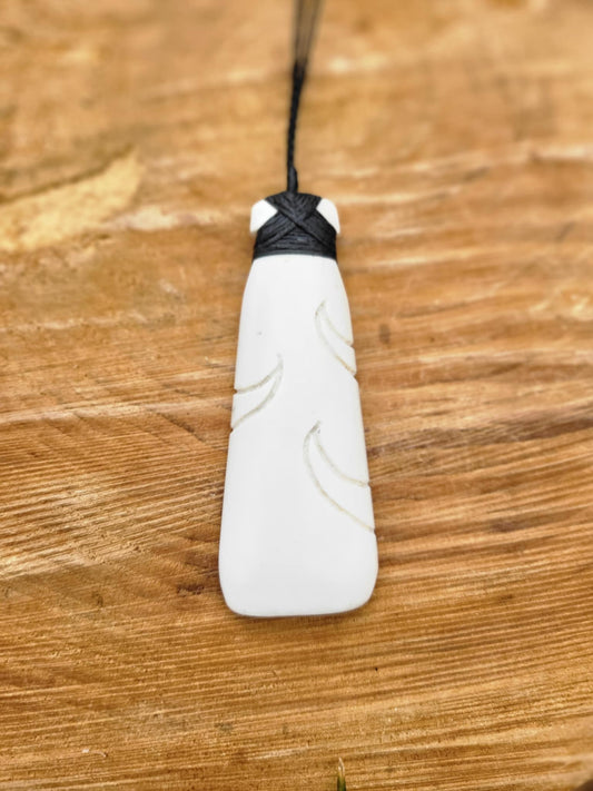 carved bone toki (adze) on black cord