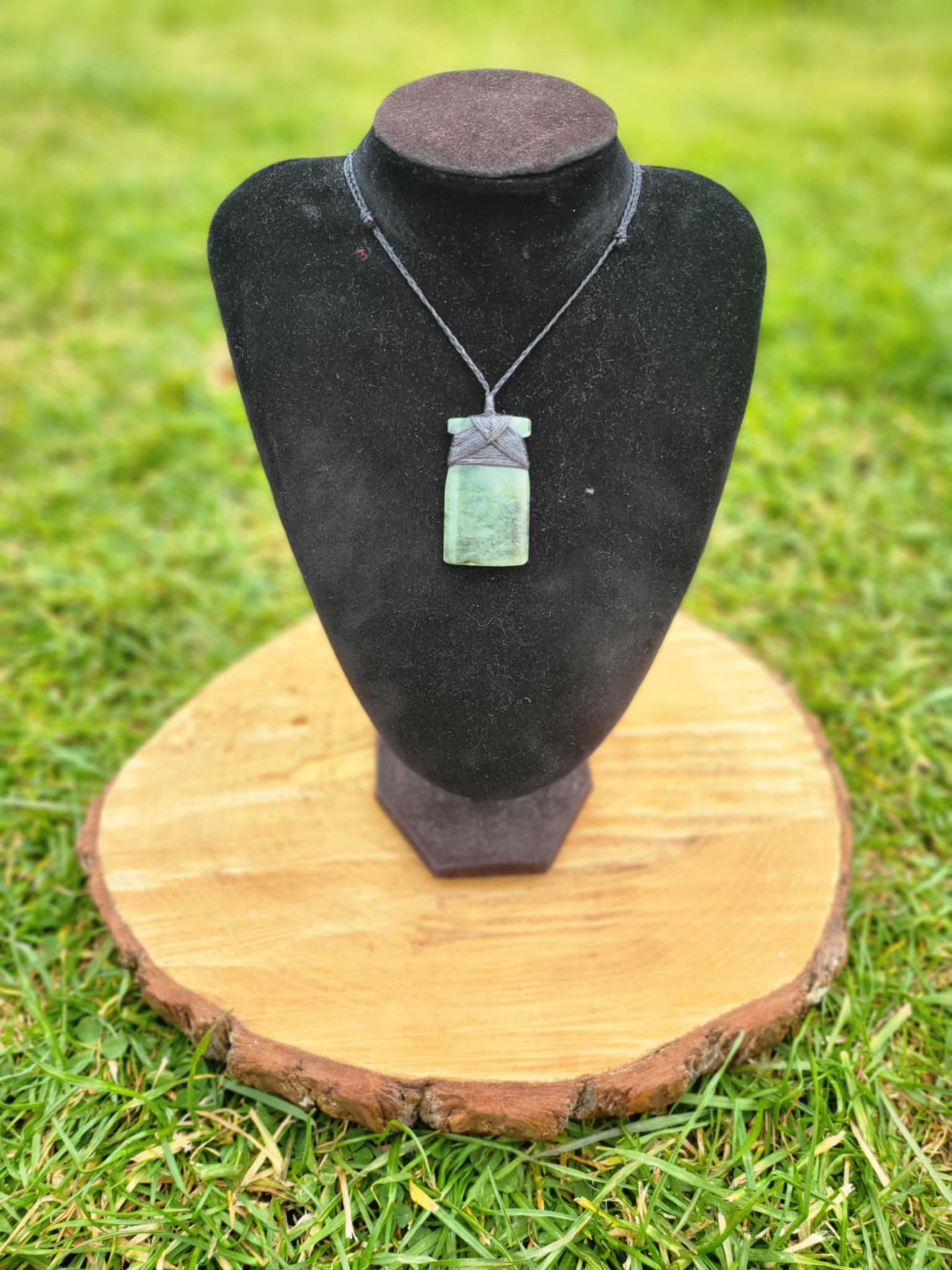 carved pounamu toki (adze) on black cord