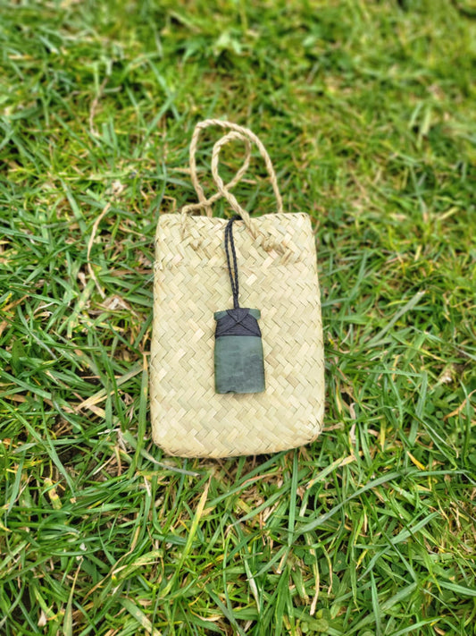 carved pounamu toki (adze) on black cord