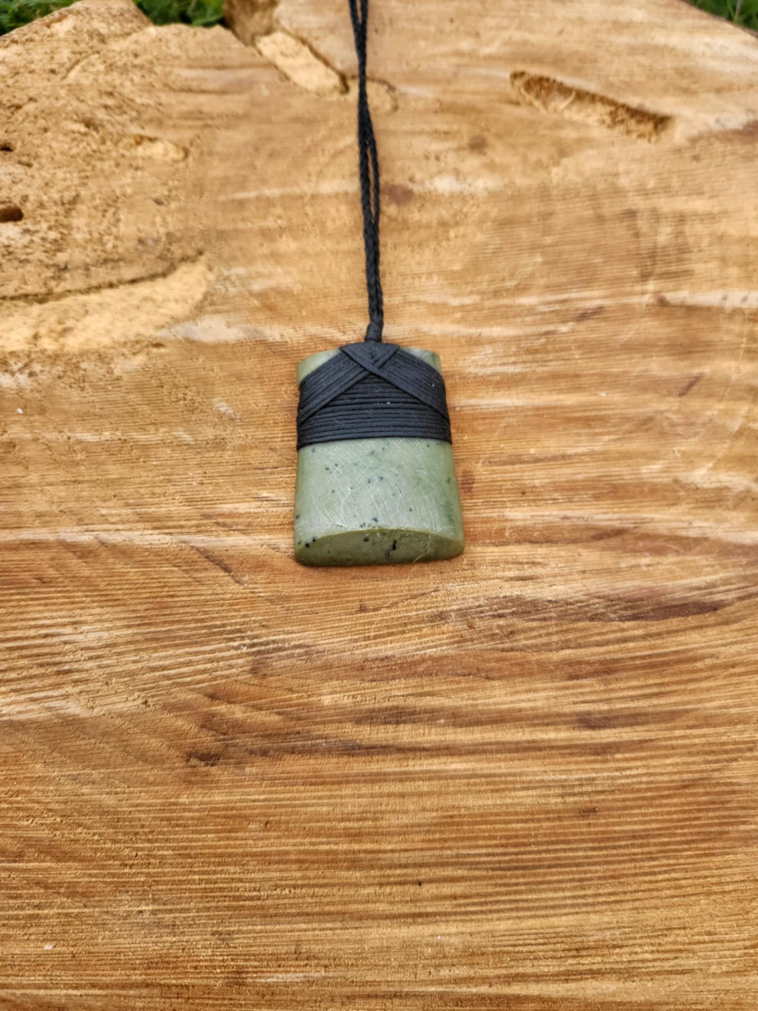light green pounamu carved toki (adze) necklace on black cord